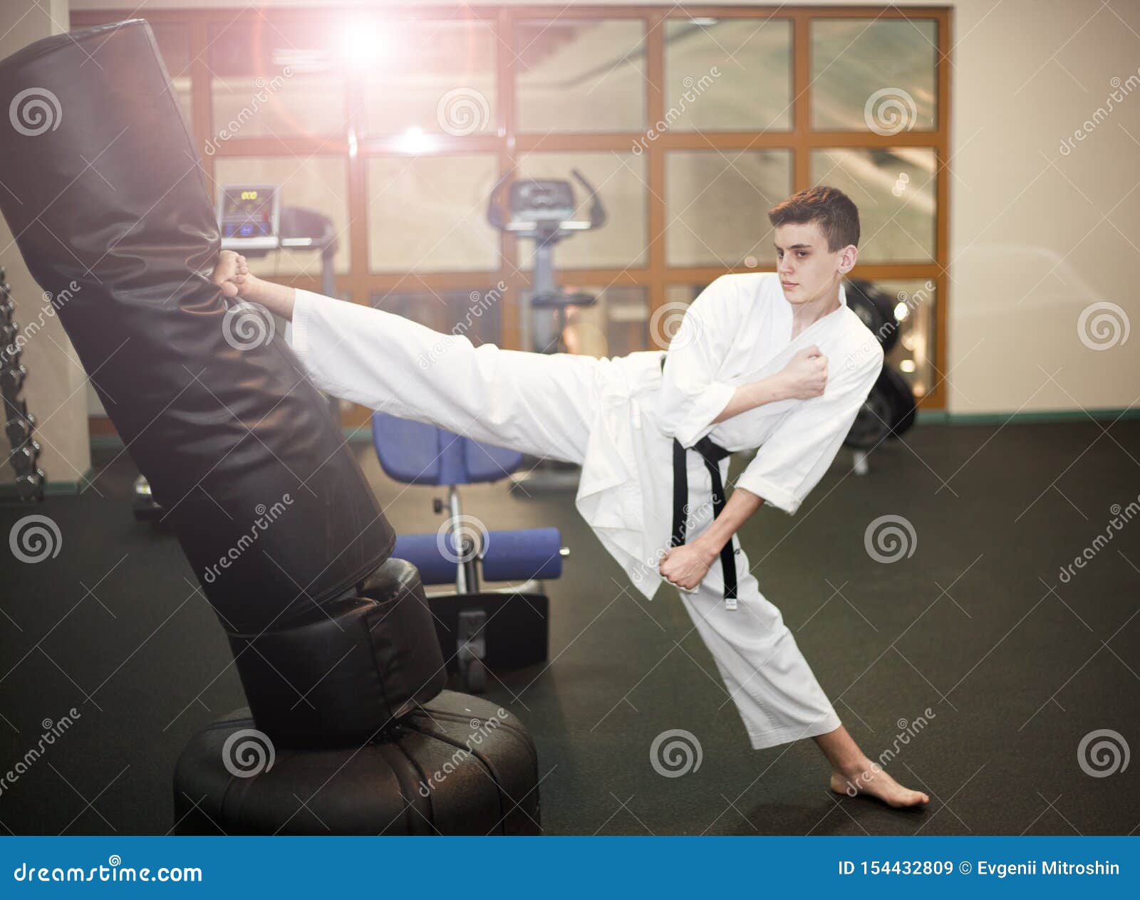 Karate. a Young Man is Practicing Kicking, Training in the Gym Stock