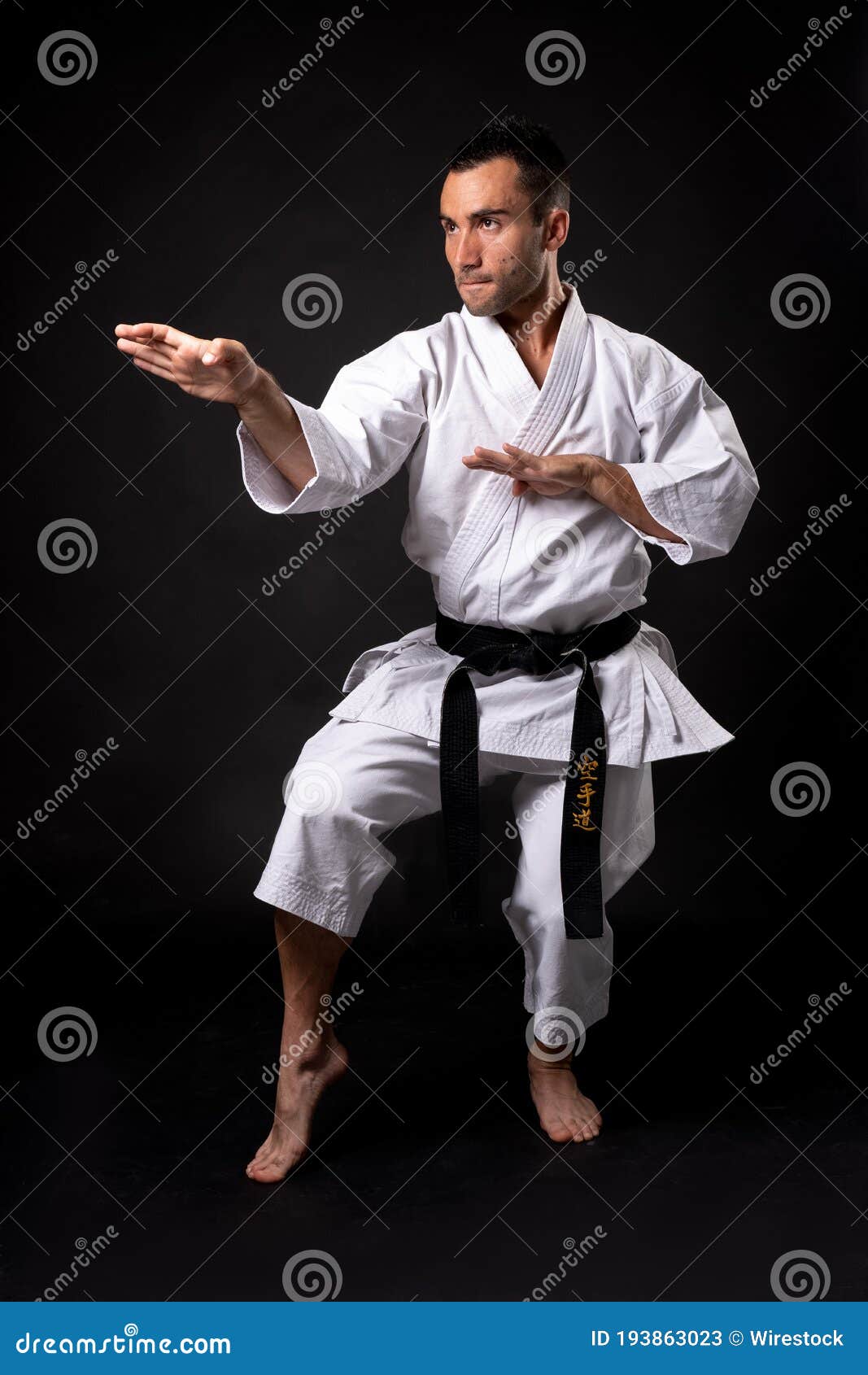 karateka practicing kata with black background