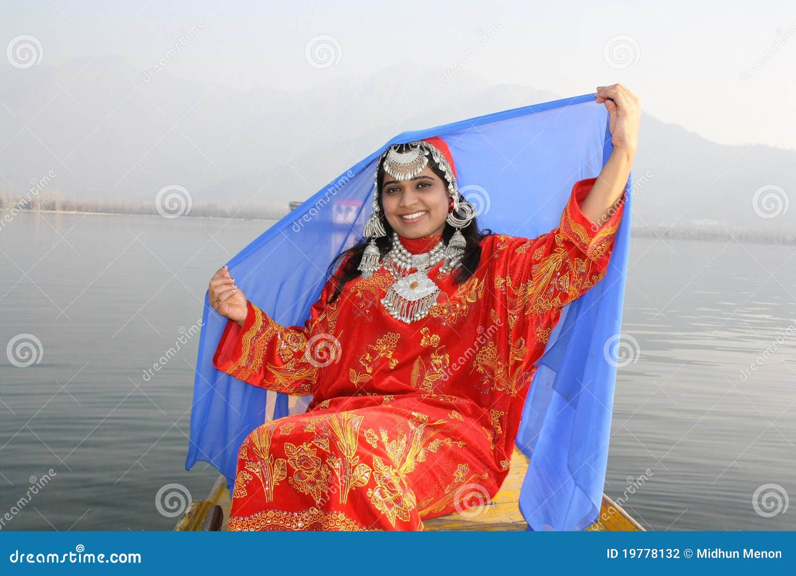 kashmiri girl lifting her blue veil