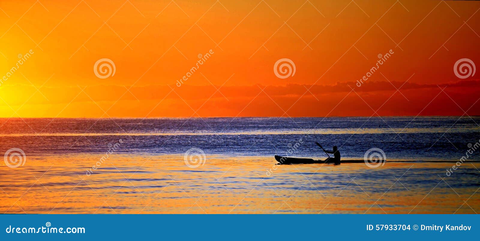 kayak in ocean at sunset