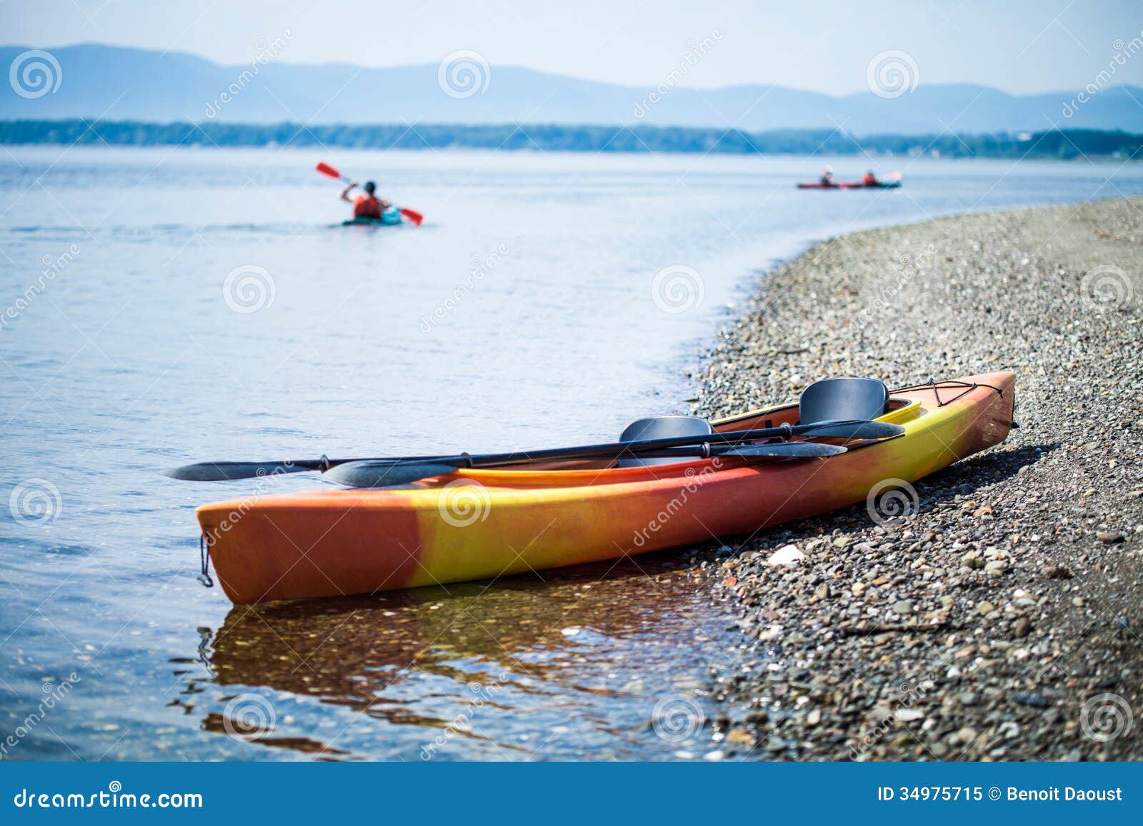 Kayak on the Sea Shore with Kayakers in the Background Stock Image ...