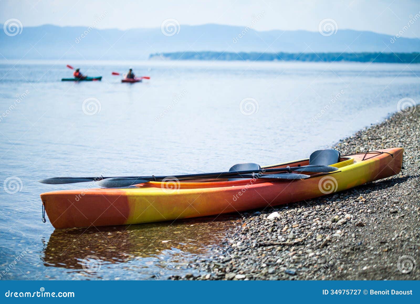 Kayak on the Sea Shore with Kayakers in the Background Stock Image ...
