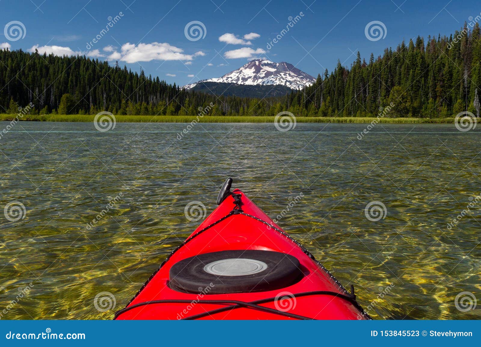 kayaking beautiful lake in summer toward mountain peak