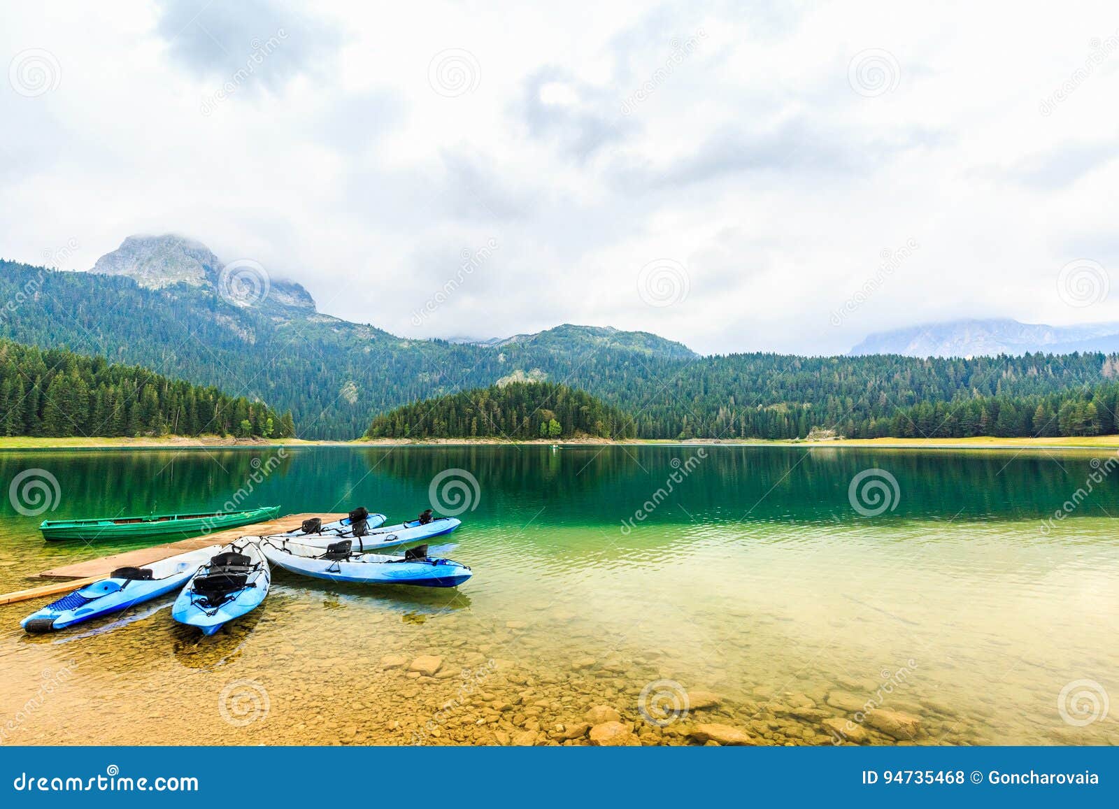 kayaks docked on the shore of black lake, durmitor national park, zabljak, montenegro.