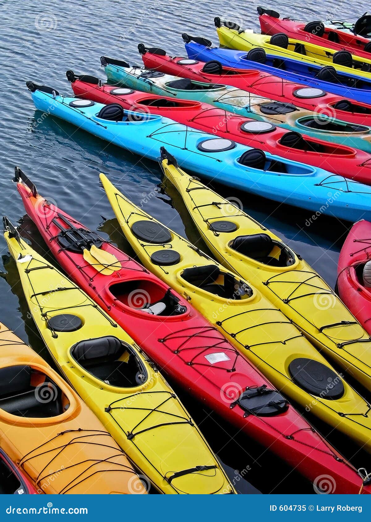 Kayaks in a row stock image. Image of water, kayaks, blue 604735