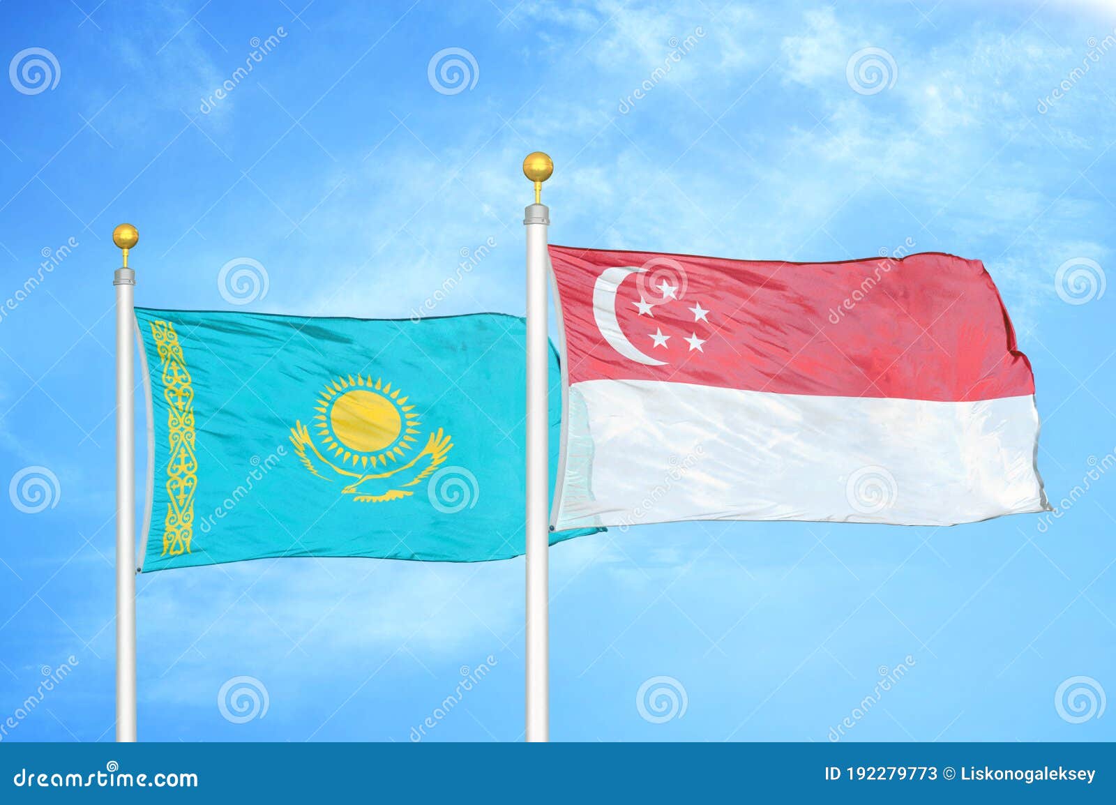 kazakhstan and singapore two flags on flagpoles and blue sky