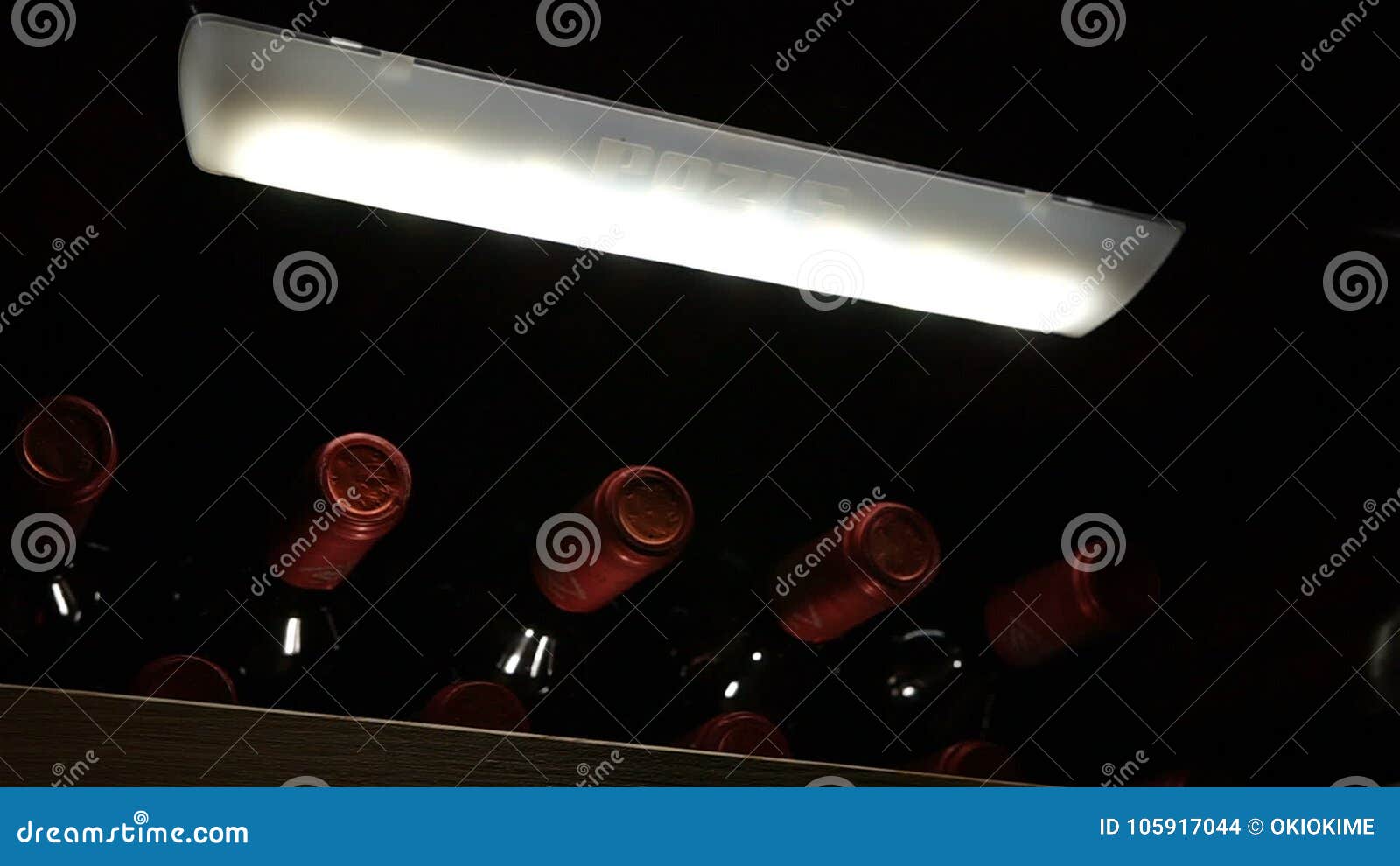 Motion Past Wine Cabinet With Bottles And Pozis Logo Lamp Stock