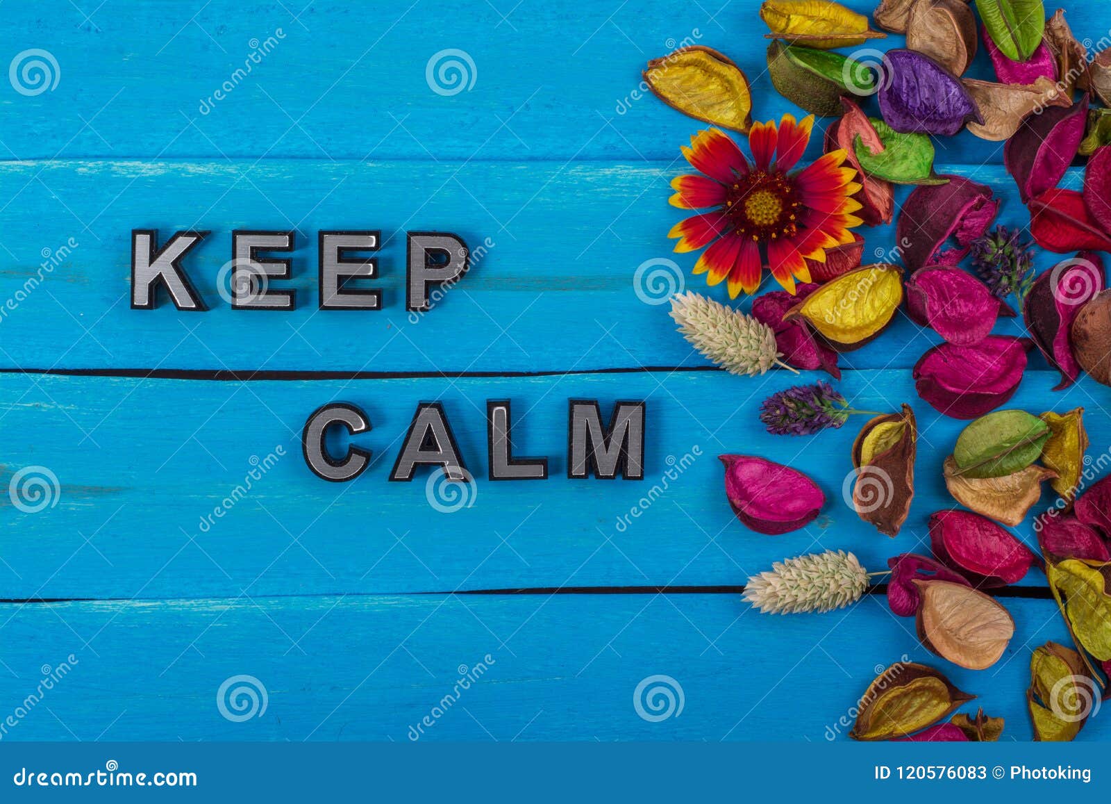 keep calm text on blue wood with flower