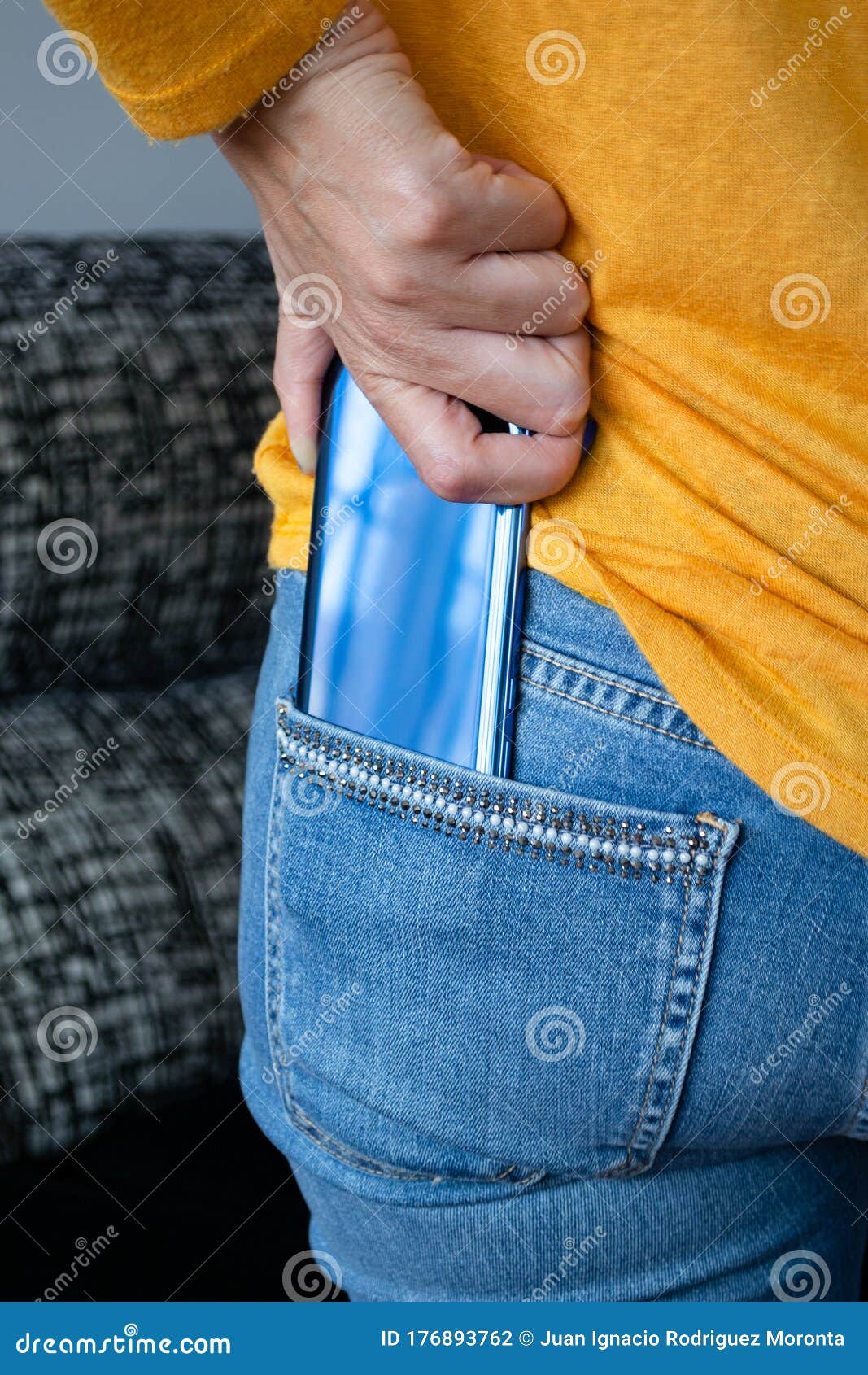 Keeping the Cell Phone in the Back Pocket of the Pants Stock Photo