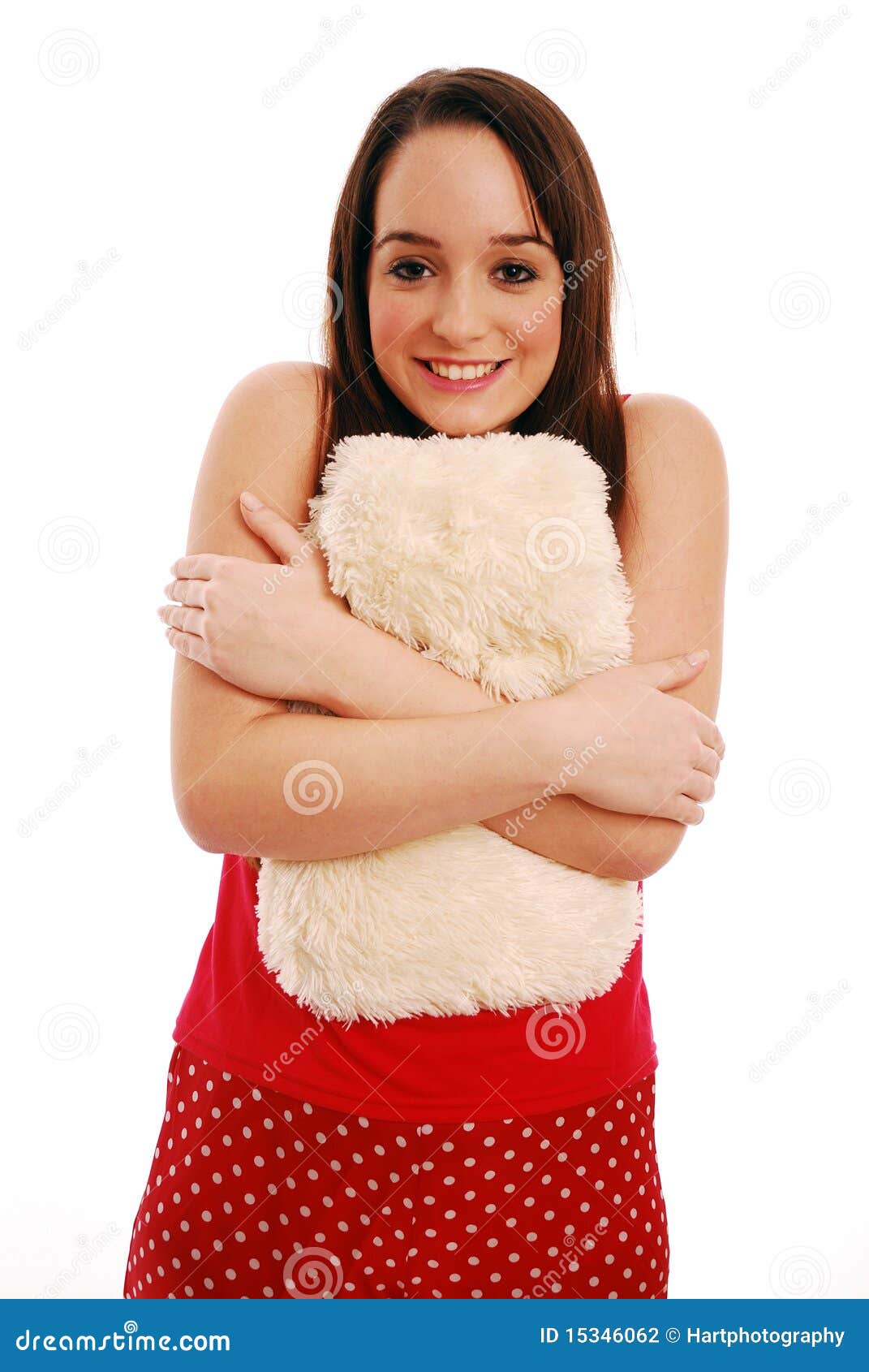 Keeping warm. Young woman holding hot water bottle to her tummy