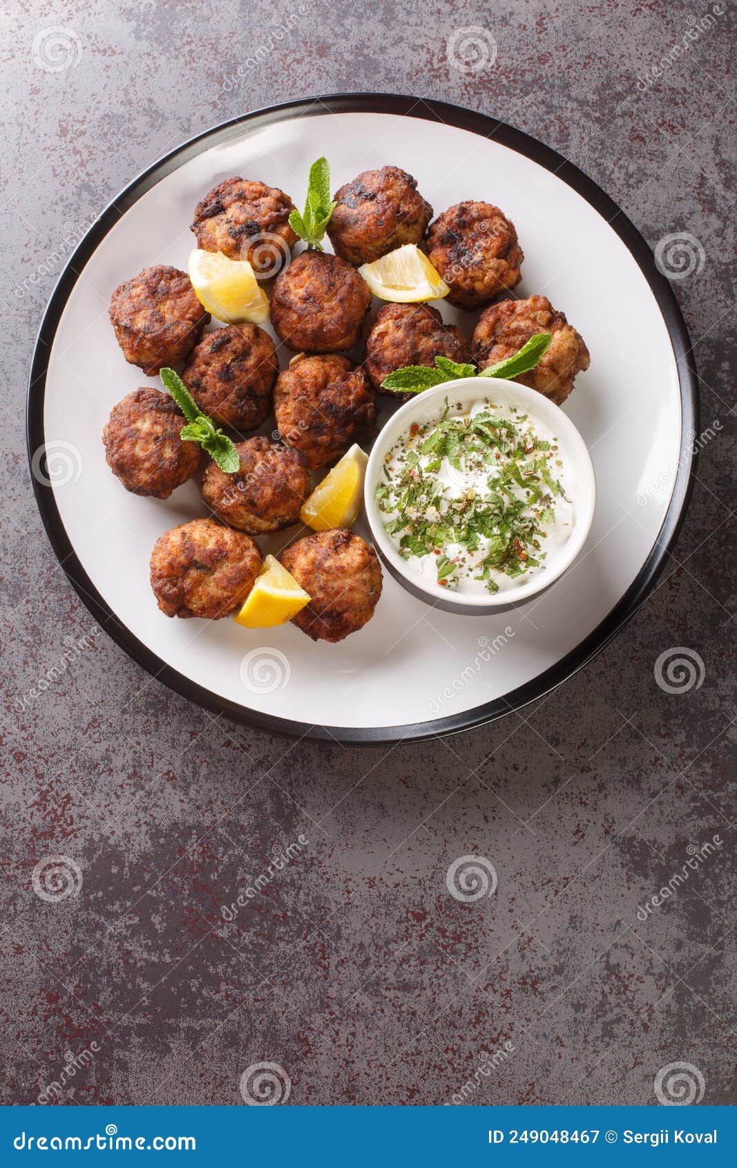 Keftedakia Fried Greek Meatballs with Tzatziki Sauce and Lemon on a ...