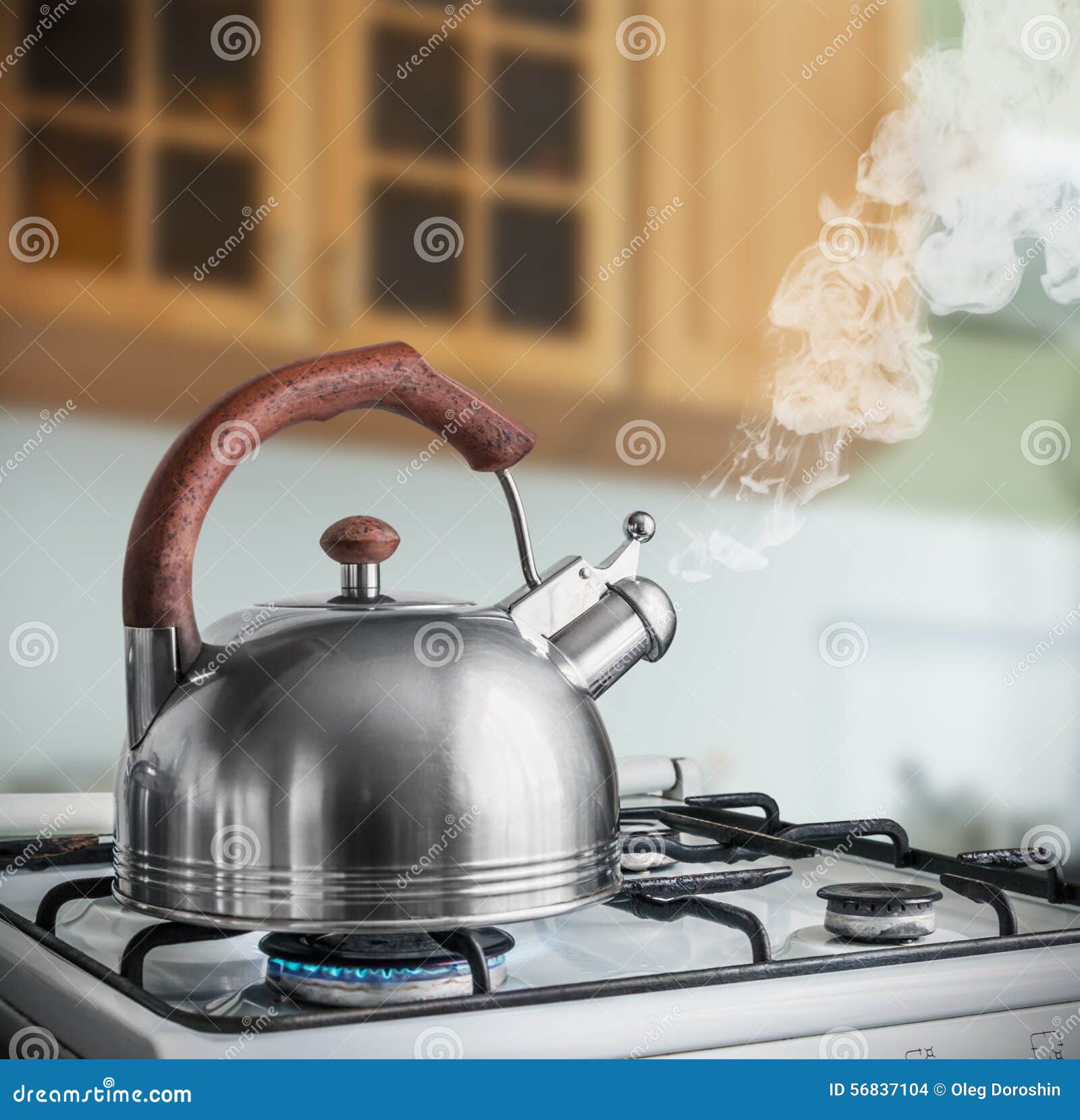 Tea kettle with boiling water on gas stove, Stock image