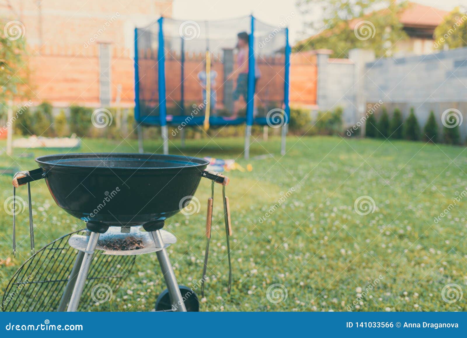 Kettle Charcoal Bbq Barbecue Grill In Garden Or Backyard Blurred Outdoor Trampoline In The Background Family Home Stock Photo Image Of Cookout Burgers 141033566