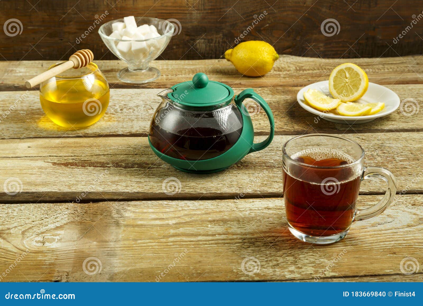 Kettle and Cup with Tea with Lemon and Sugar on the Table Stock Photo