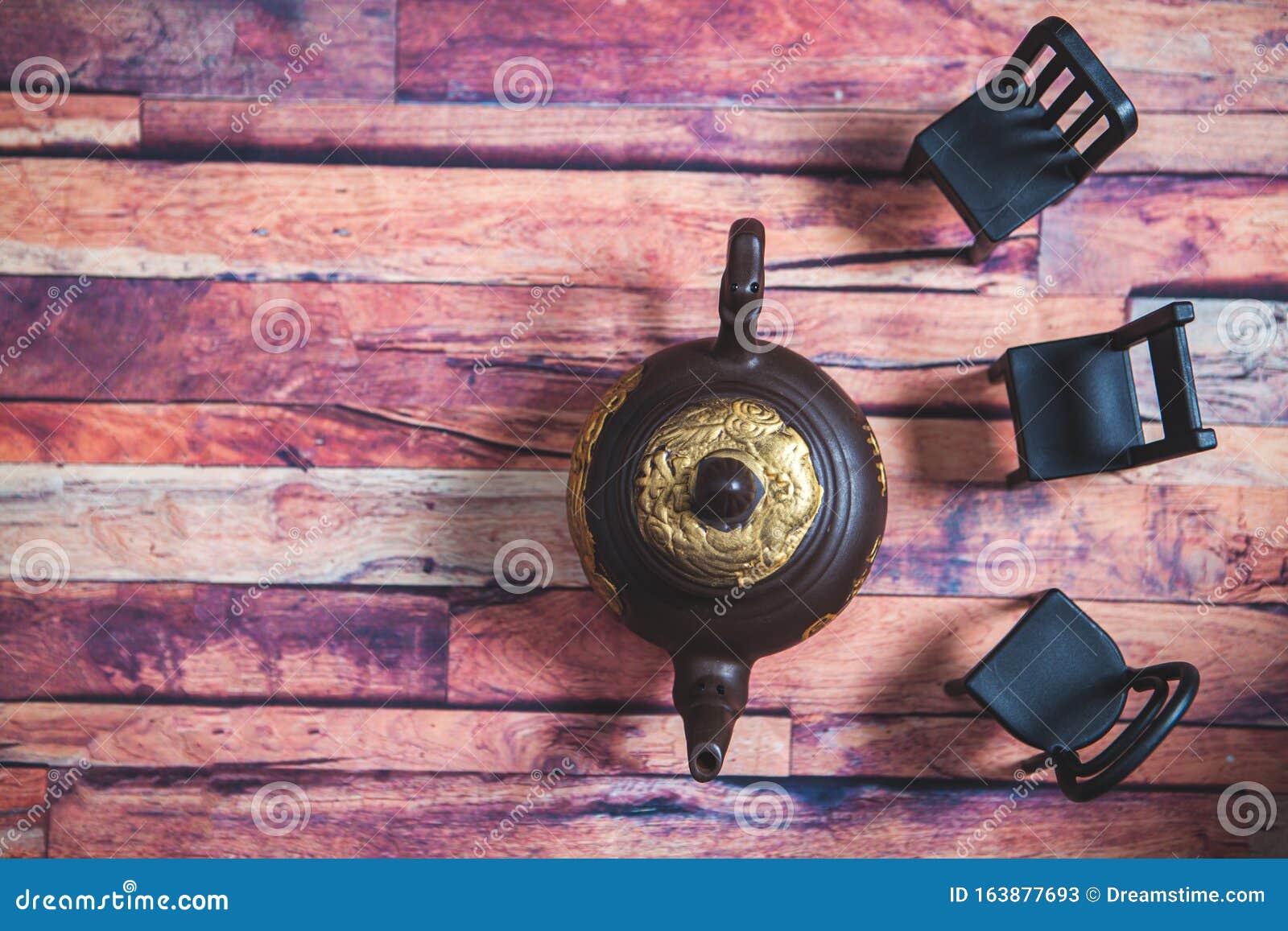 clay teapot with tea on a wooden table