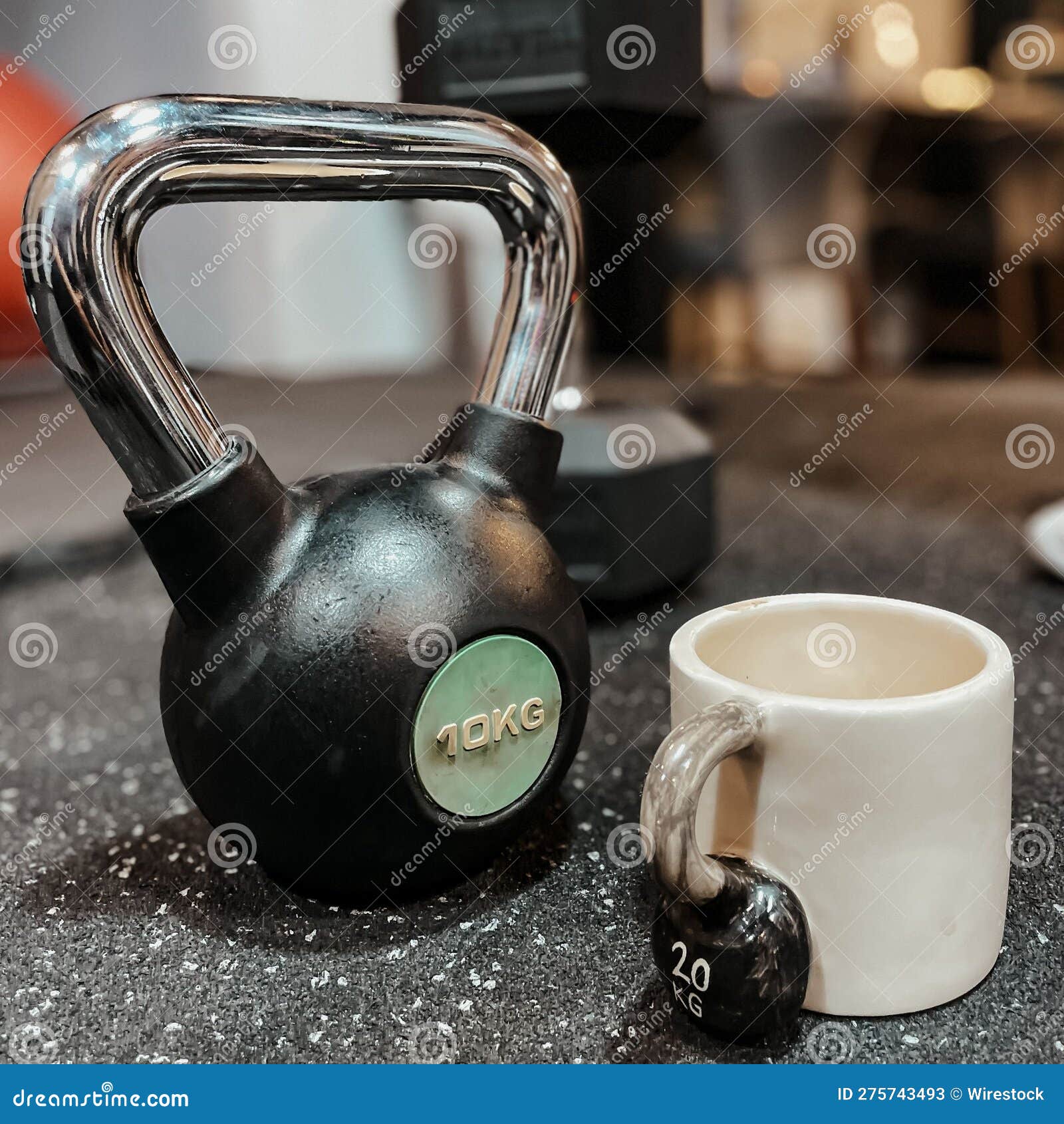 Kettlebell Next To a White Ceramic Mug with Kettlebell Design in a Gym