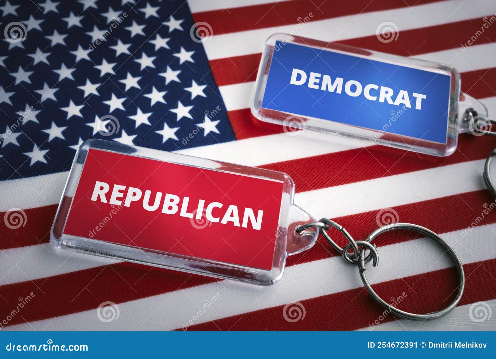 keychain of the republican party and the democratic party on the background of the us flag. opposition of republicans and