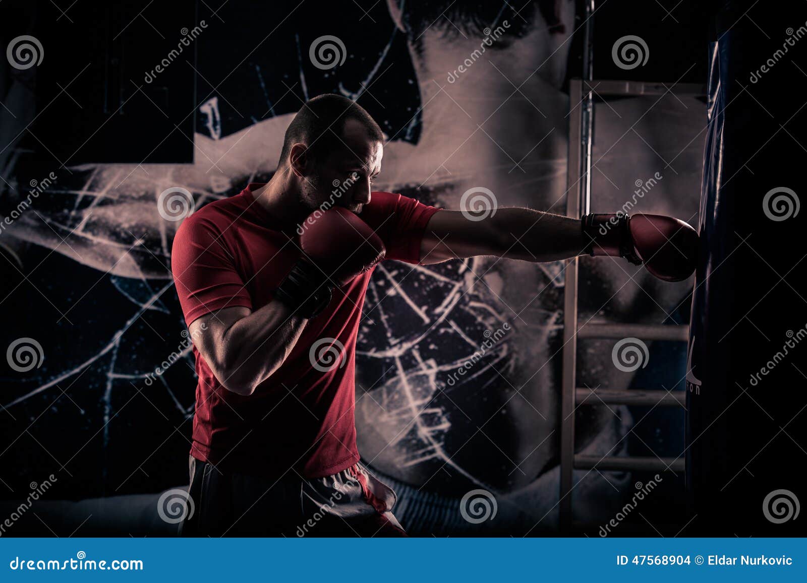 kick boxer boxing as exercise for the big fight. boxer hits punching bag. young boxer trains on punching bag