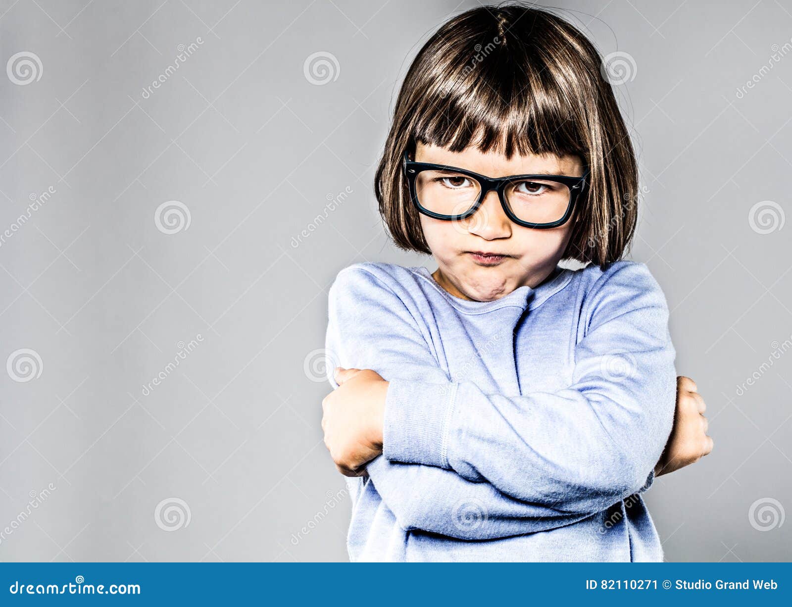 kid body language with sulking, pouting small child crossing arms