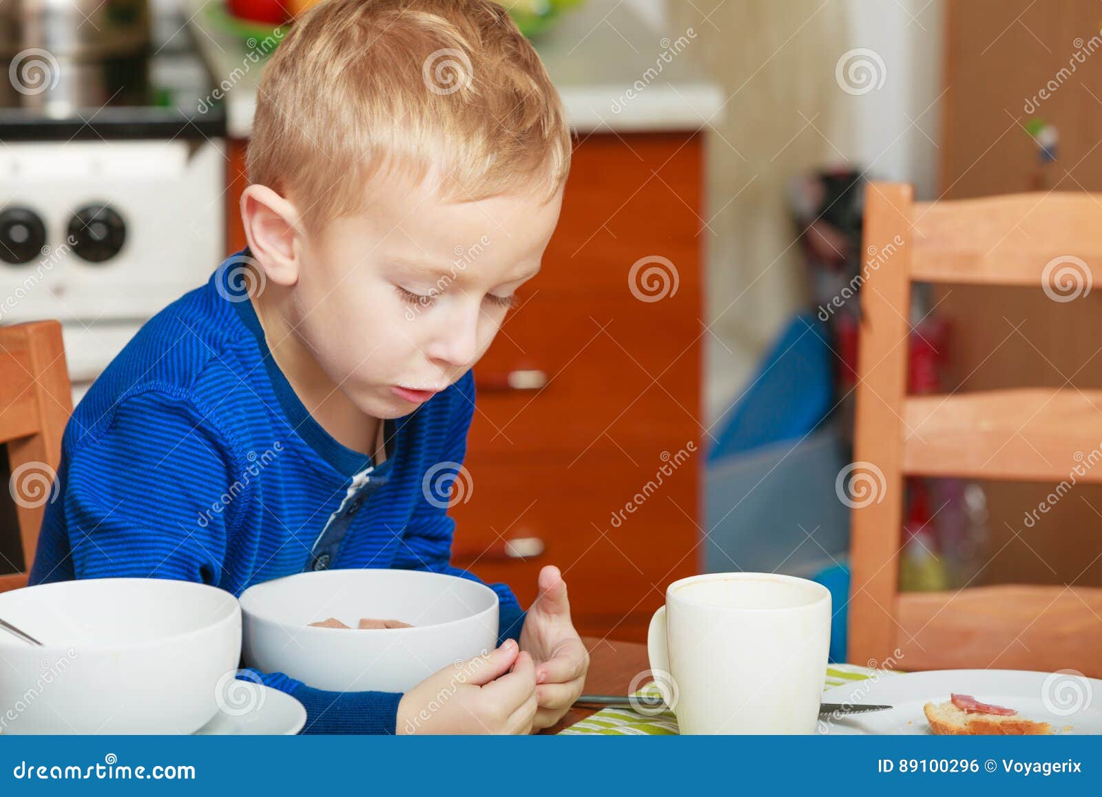 Kid Boy Eating Breakfast Cereals And Milk In Bowl Stock Photo Image