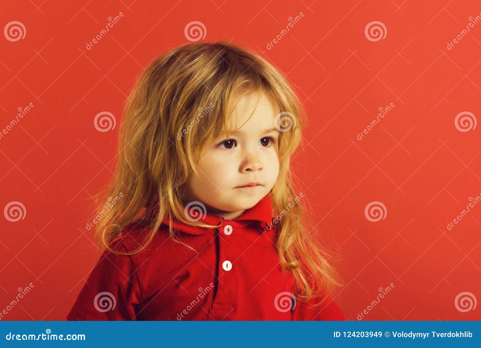 Small Baby Boy With Long Blonde Hair In Red Shirt Stock Image