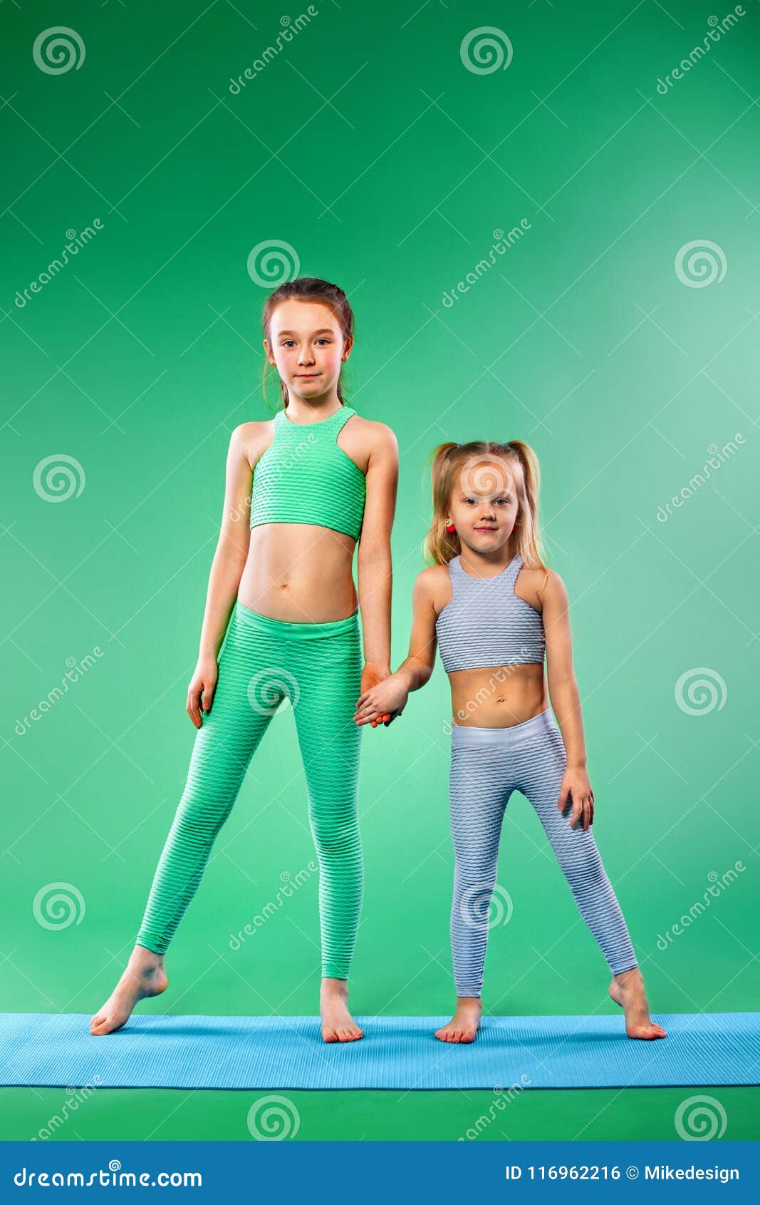 Kid Girl Doing Fitness Exercises on Green Background Stock Photo ...