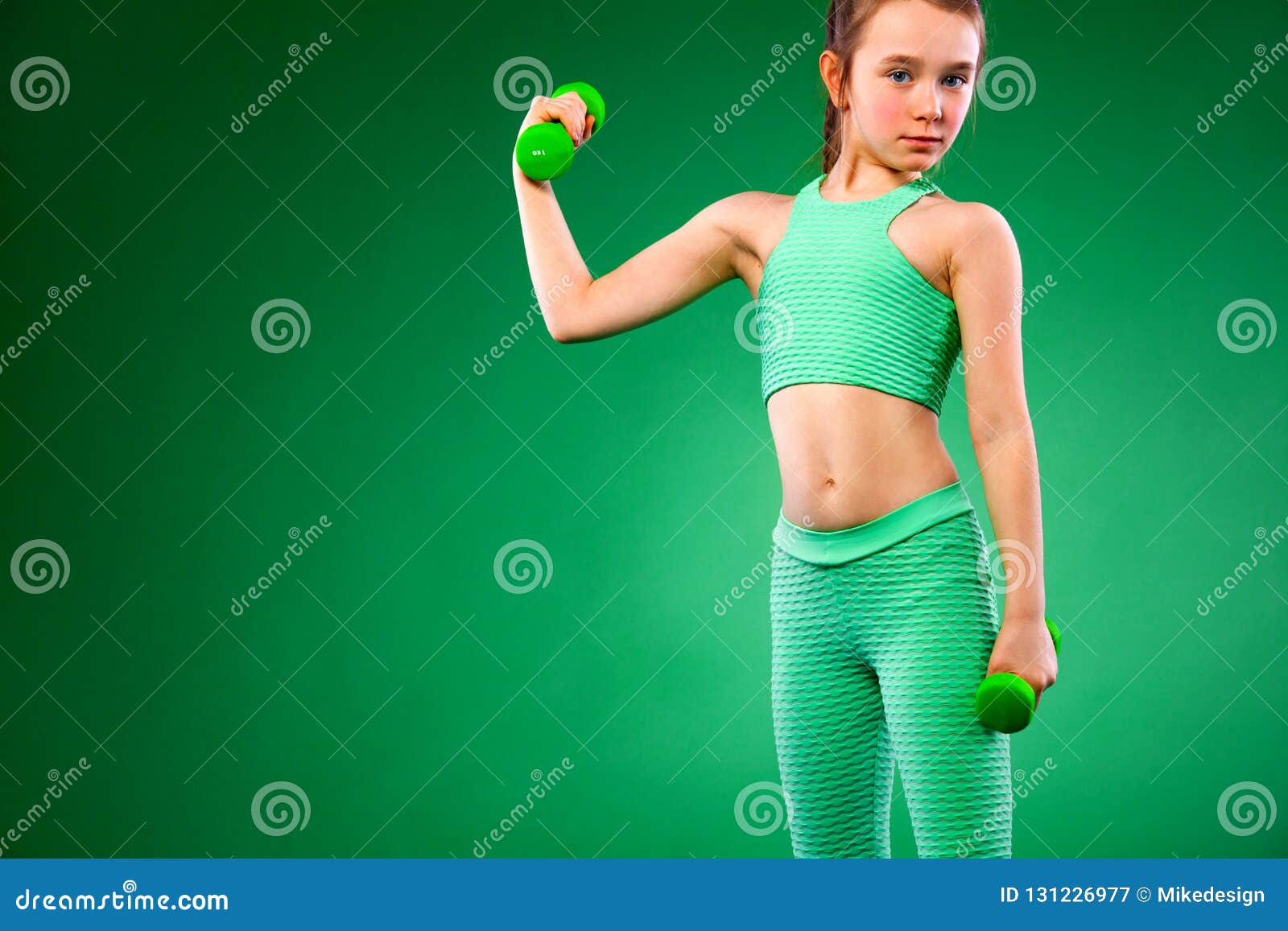 Kid Girl Doing Fitness Exercises On Green Background Stock Image ...