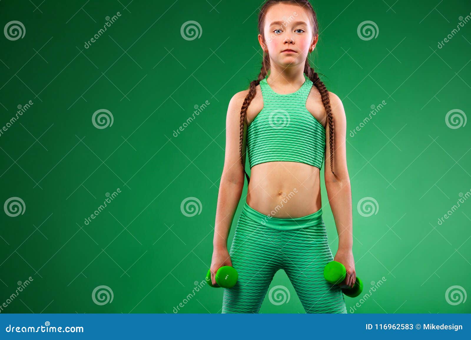 Kid Girl Doing Fitness Exercises with Dumbbells on Green Background ...