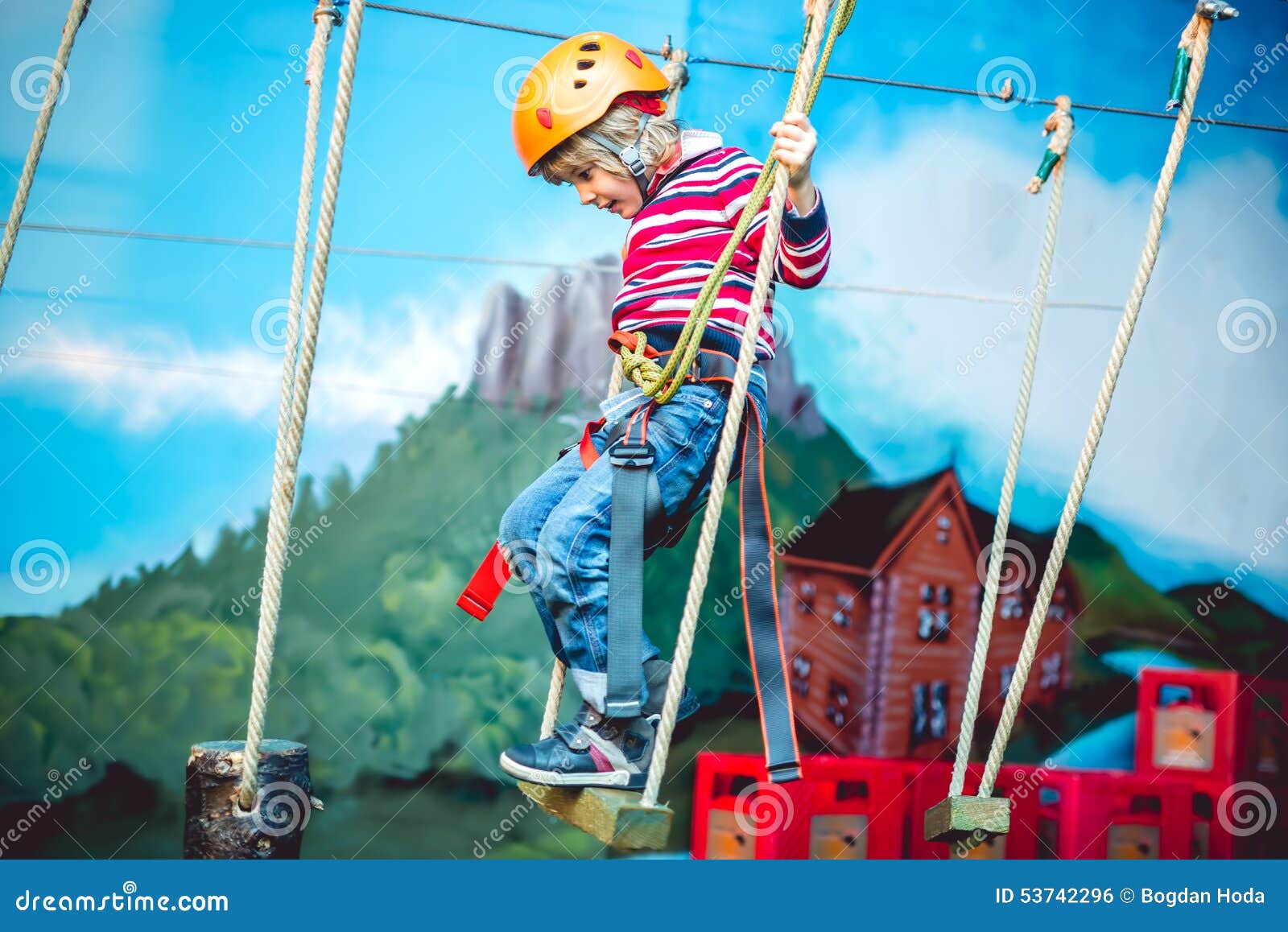 kid having a good time and having fun at an adventure playground with diferent activities. happy childhood concept