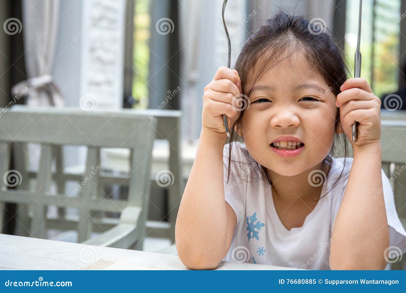 Kid Holding Spoon and Fork stock image. Image of girl 76680885