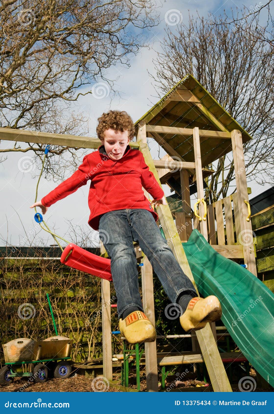 Boy Jumping Off Swing Stock Image 47015101