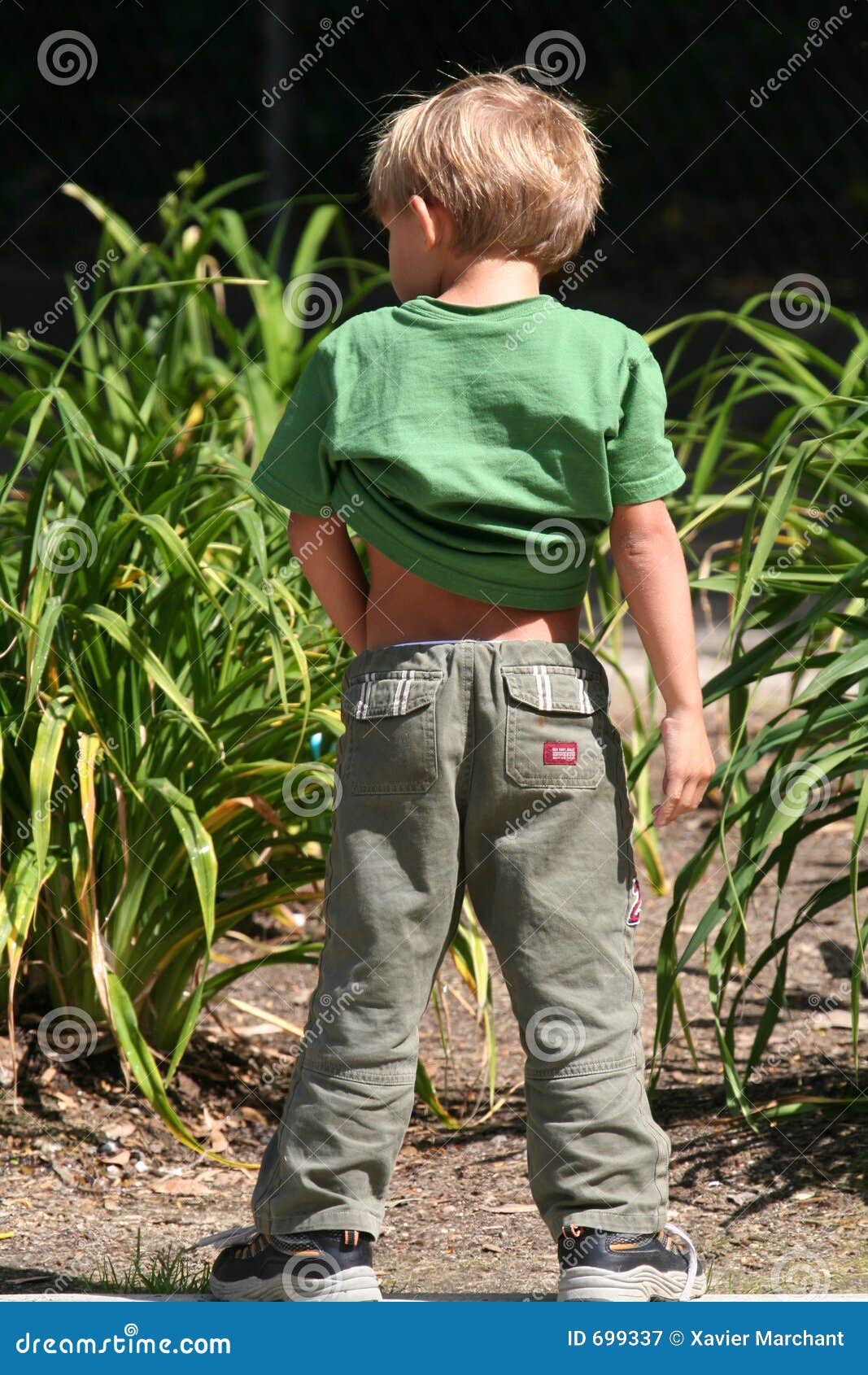 Little boy pee grass 
