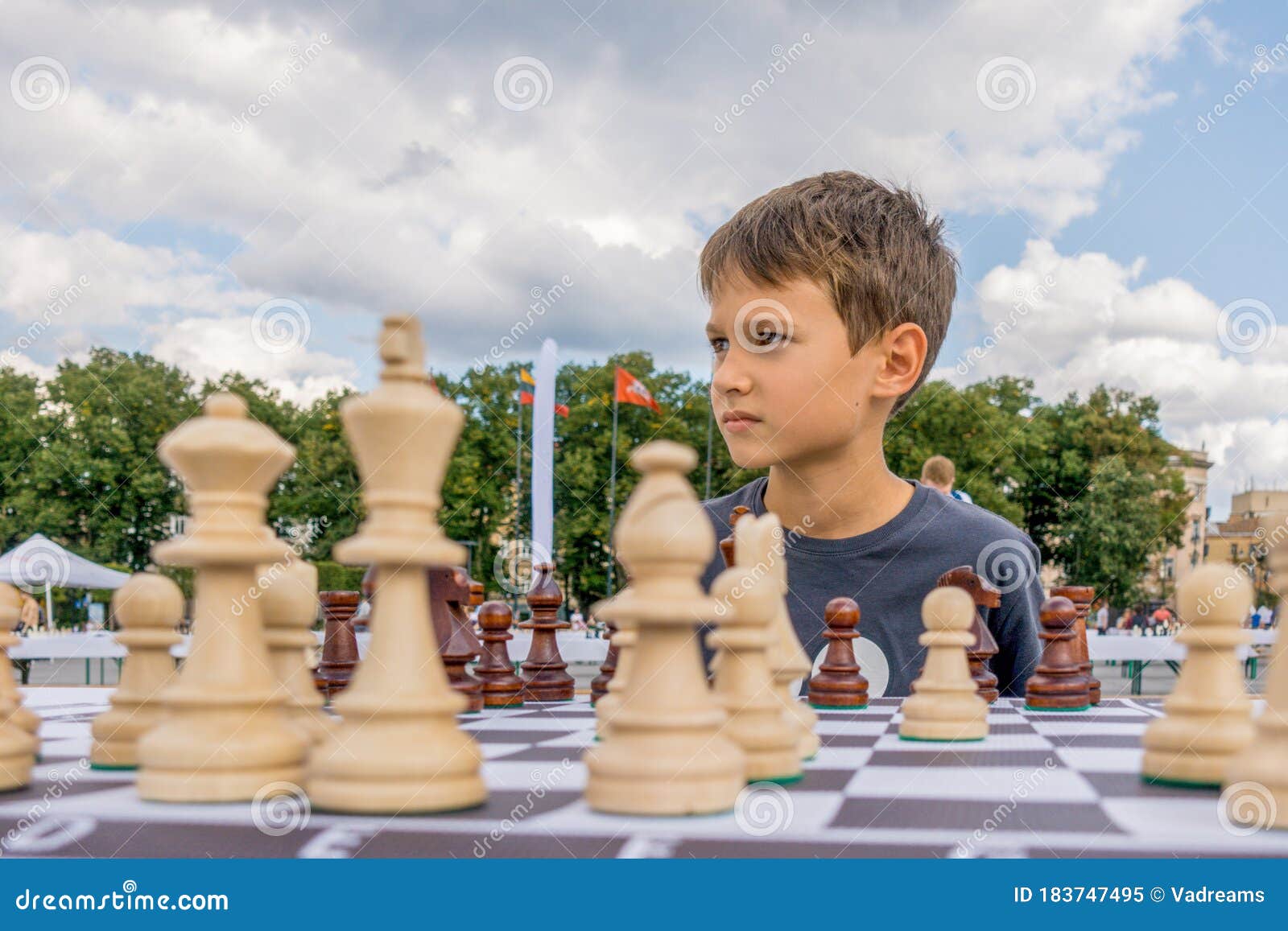 Teenage boy learning to play chess online with tablet computer