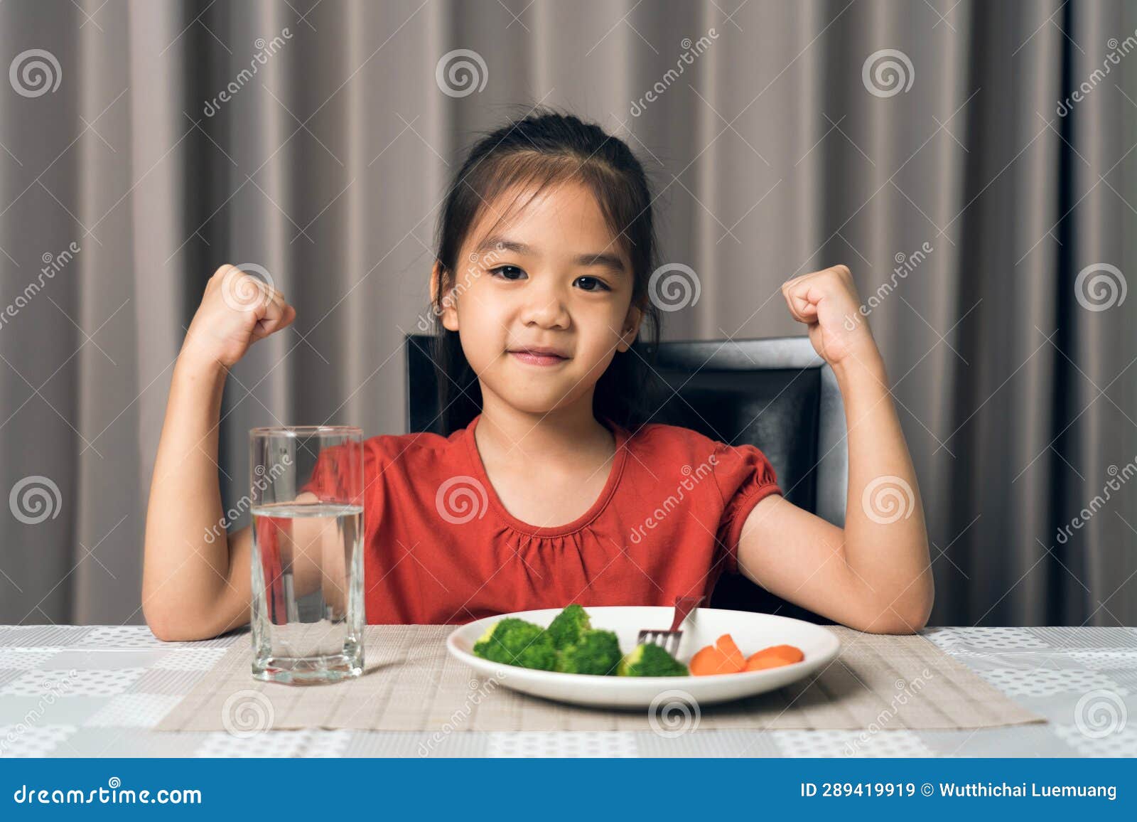 Kid Shows Strength of Eats Vegetables and Nutritious Food Stock Image