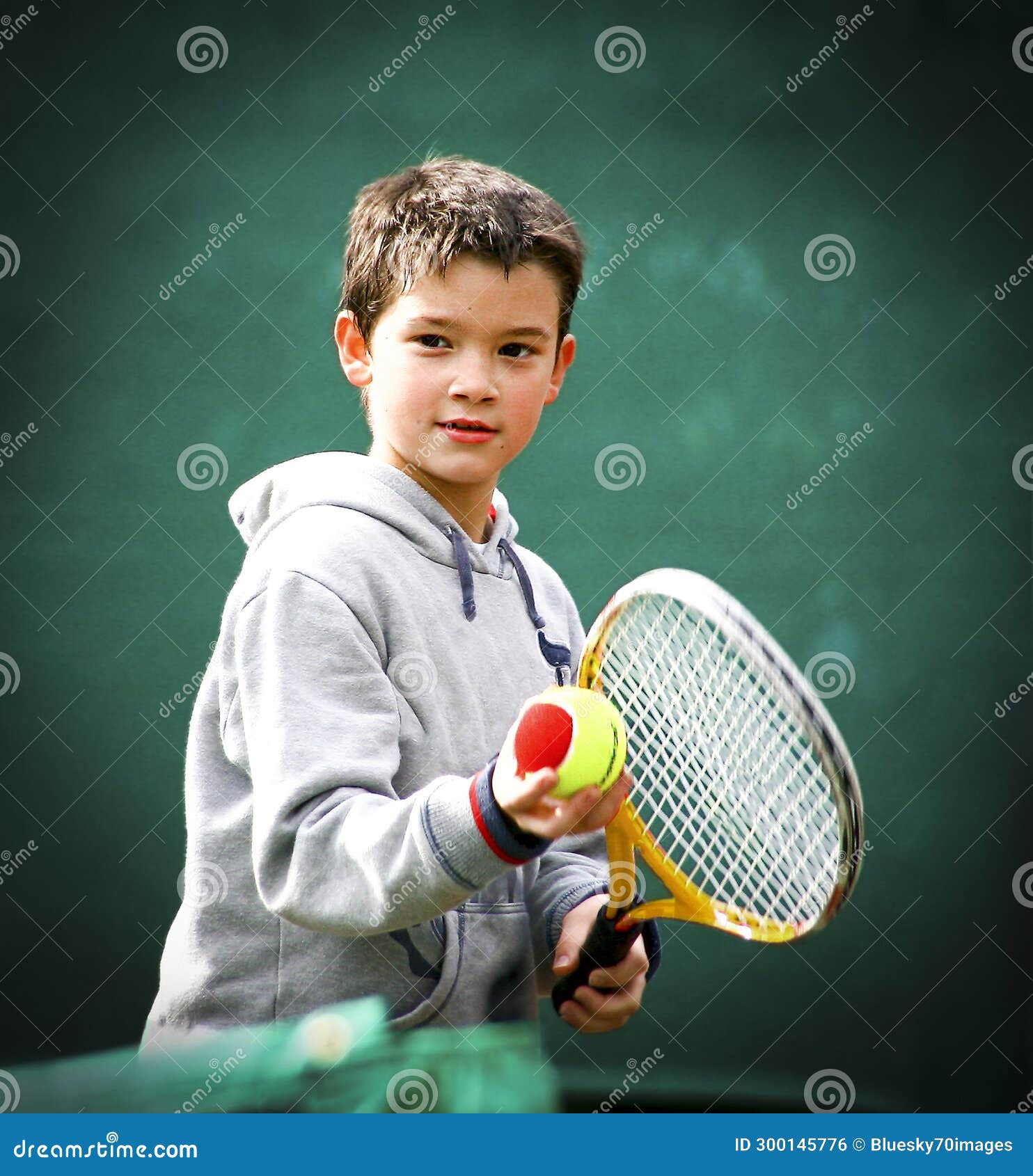First Tennis Lessons for the Smiling Kid with the Two Colours Ball for