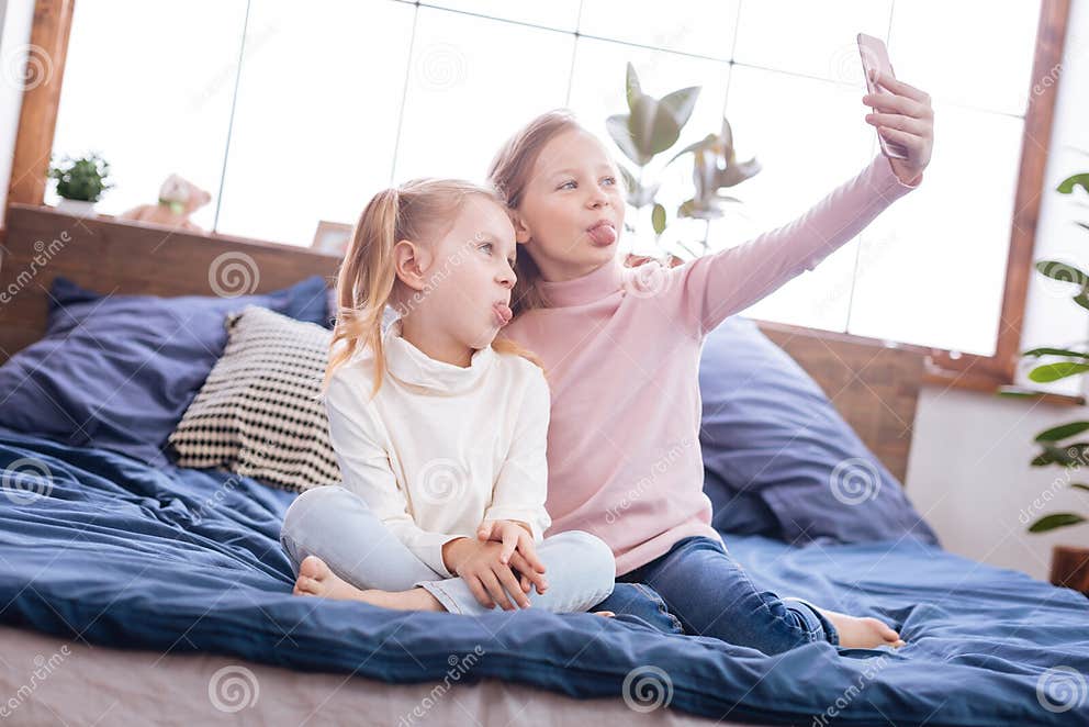 Exuberant Young Sisters Putting Their Tongues Out Stock Photo - Image ...