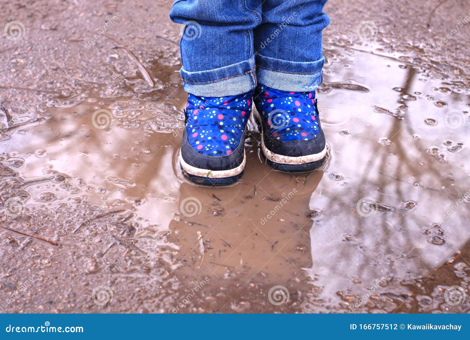 Kids Boots In Muddy Puddle. Colorful 