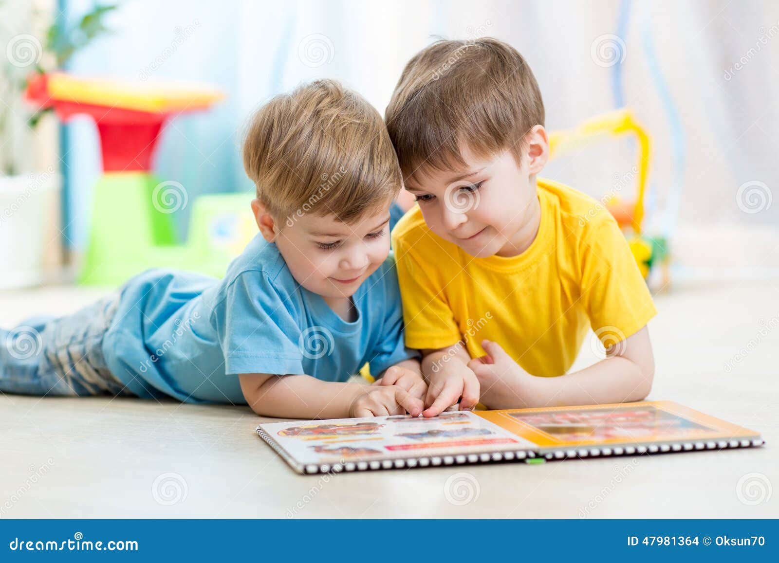 kids brothers read a book at home