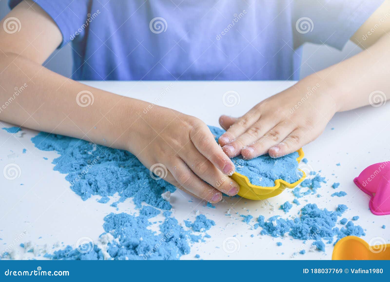 kids creativity. kinetic sand games for child development at home. sand therapy. children`s hands making moldes. selective focus,