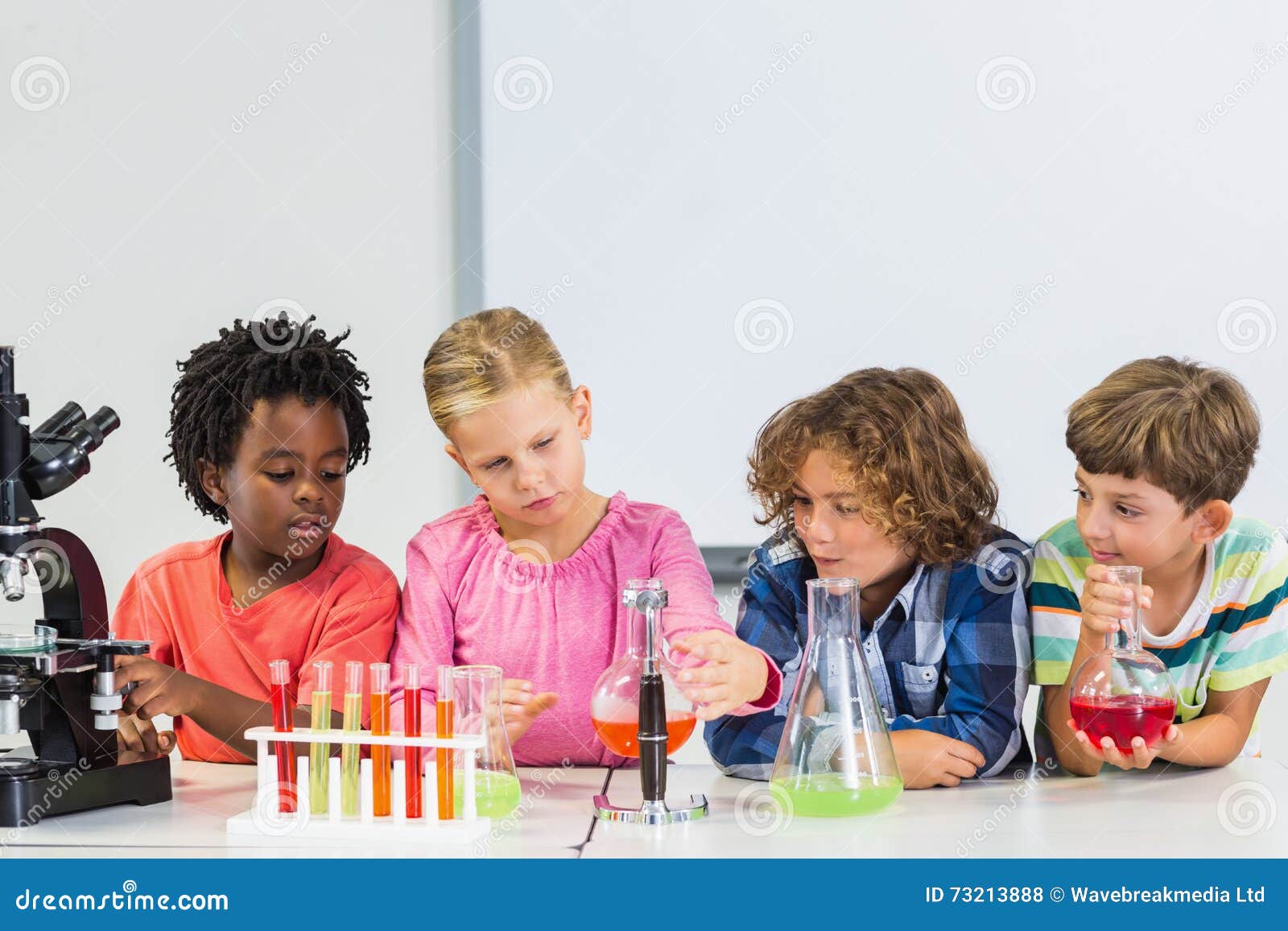 kids doing a chemical experiment in laboratory