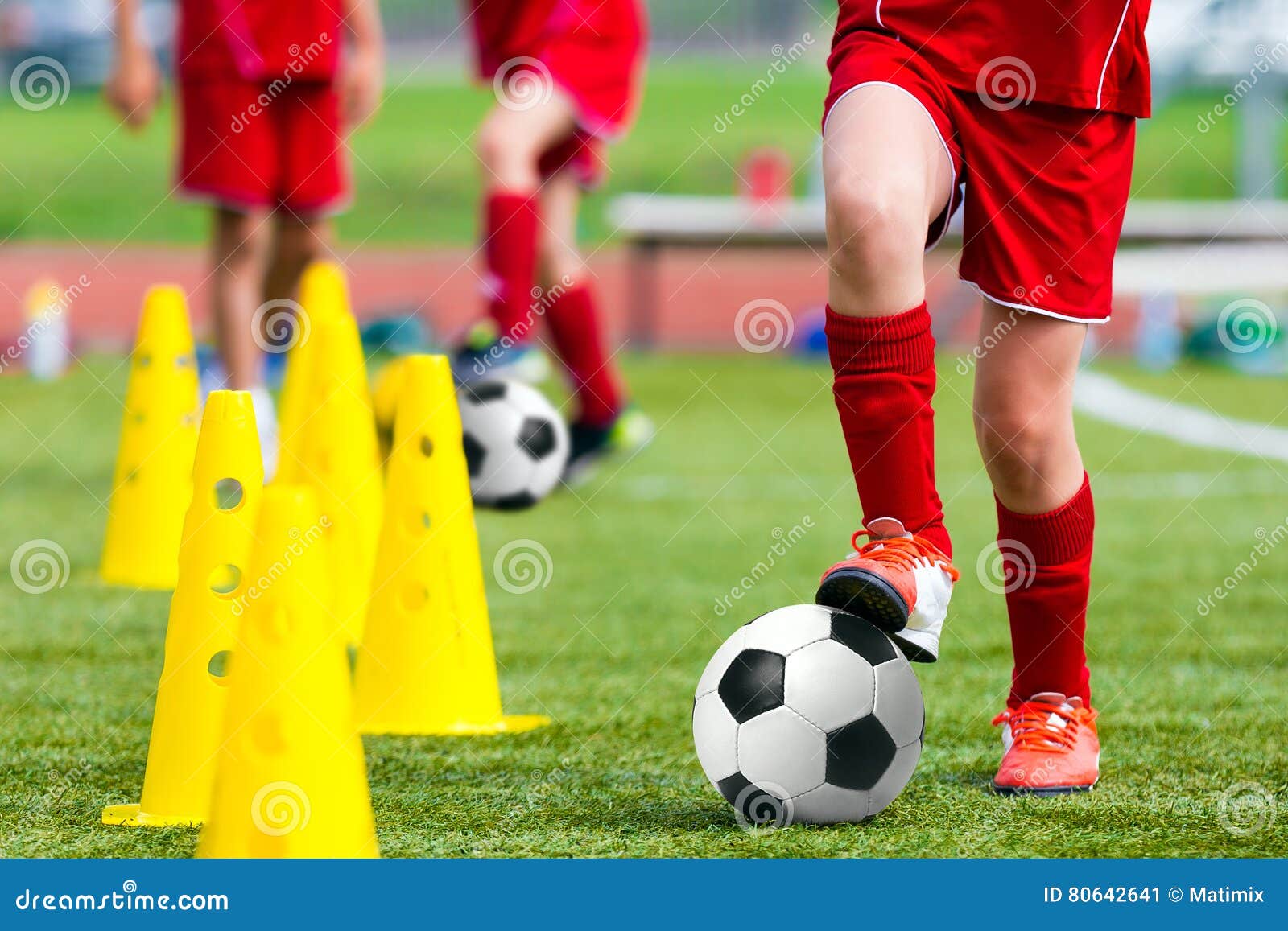 kids football soccer training.young athlete with football ball