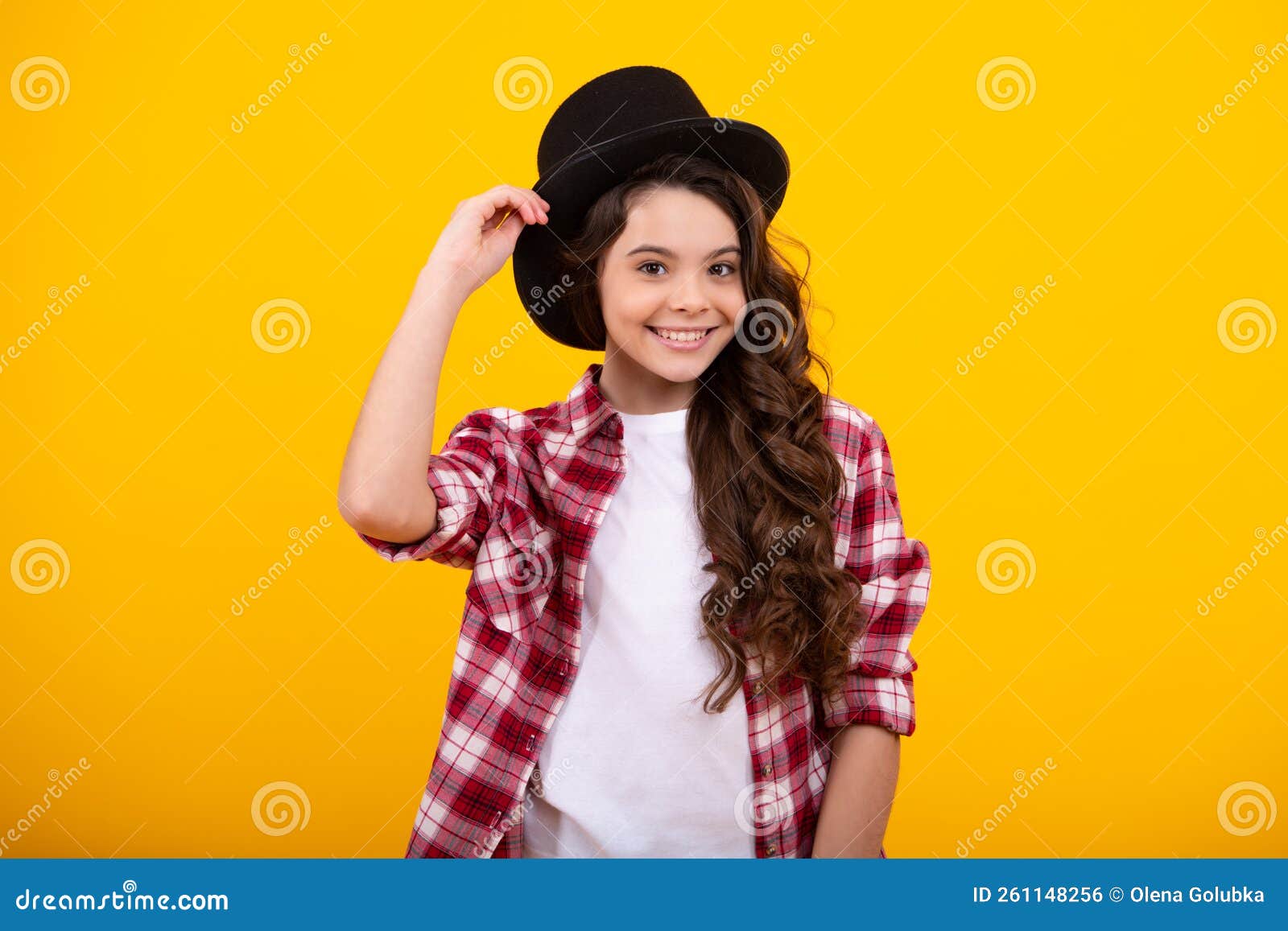 kids girl in old fashion clothes. elegent hat, cylinder hat  on yellow background. headwear. clothes accessories
