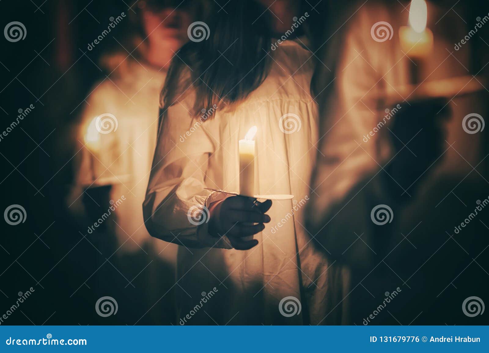 kids are handling candles in the traditionall dresses. celebration of lucia day in sweden