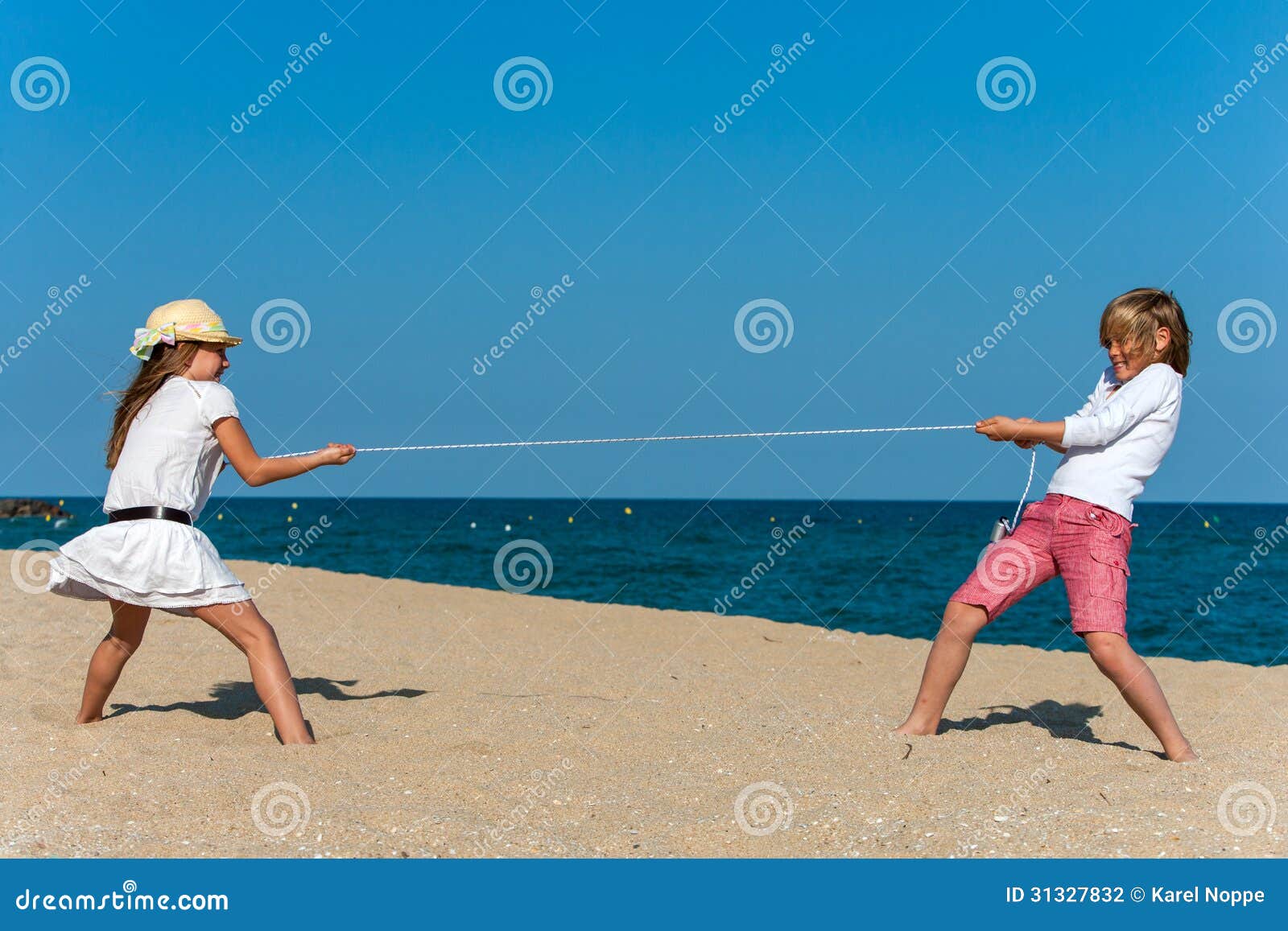 Kids Having a Rope War on the Beach. Stock Photo Image of smiling