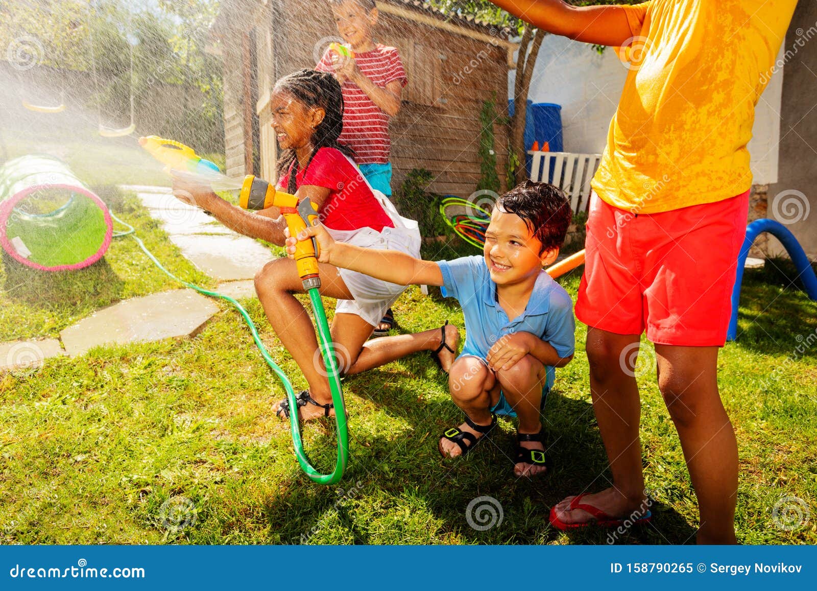 Group Of Kids Play Water Gun Fight Game Outside Stock Image Image Of