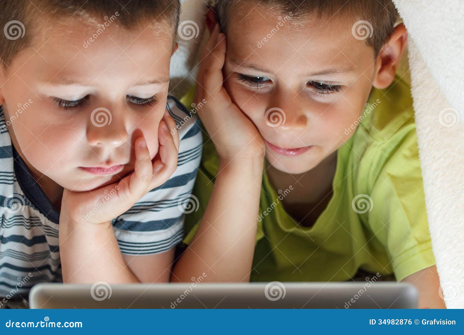Kids hiding under blanket stock photo. Image of bedroom 34982876