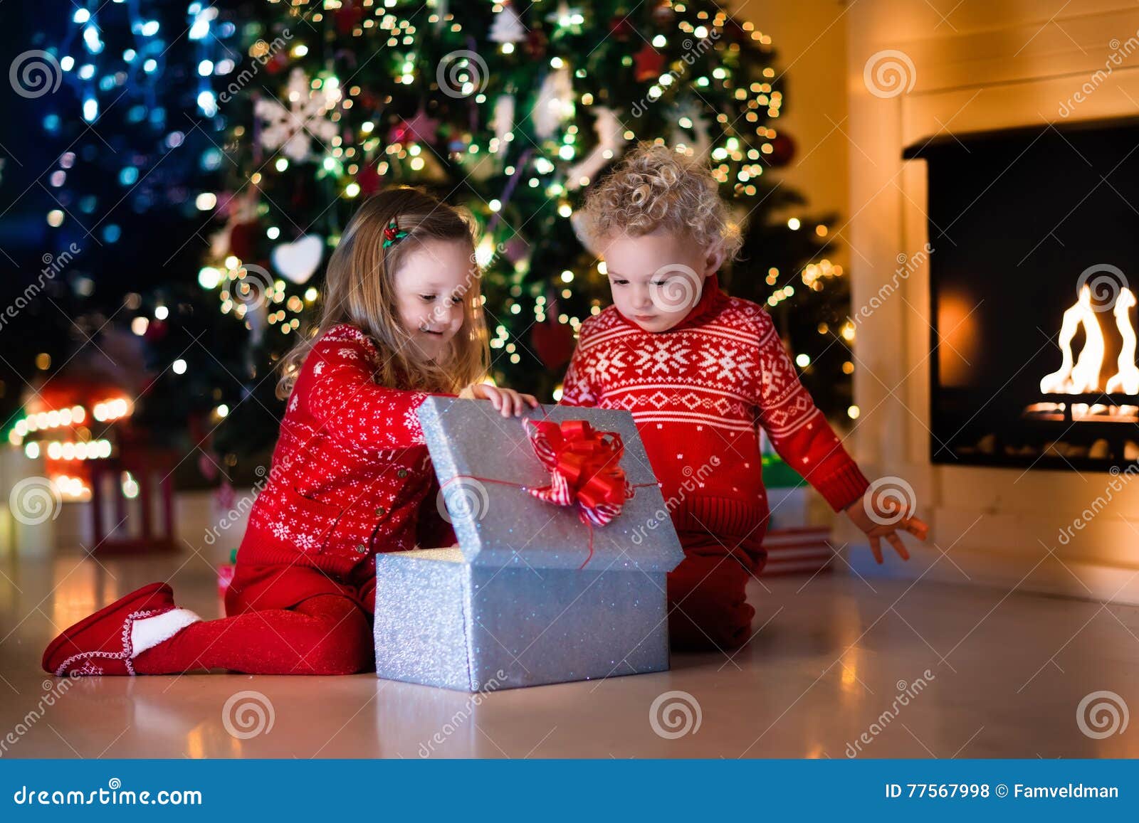 Kids Opening Christmas Presents at Fireplace Stock Photo  Image of