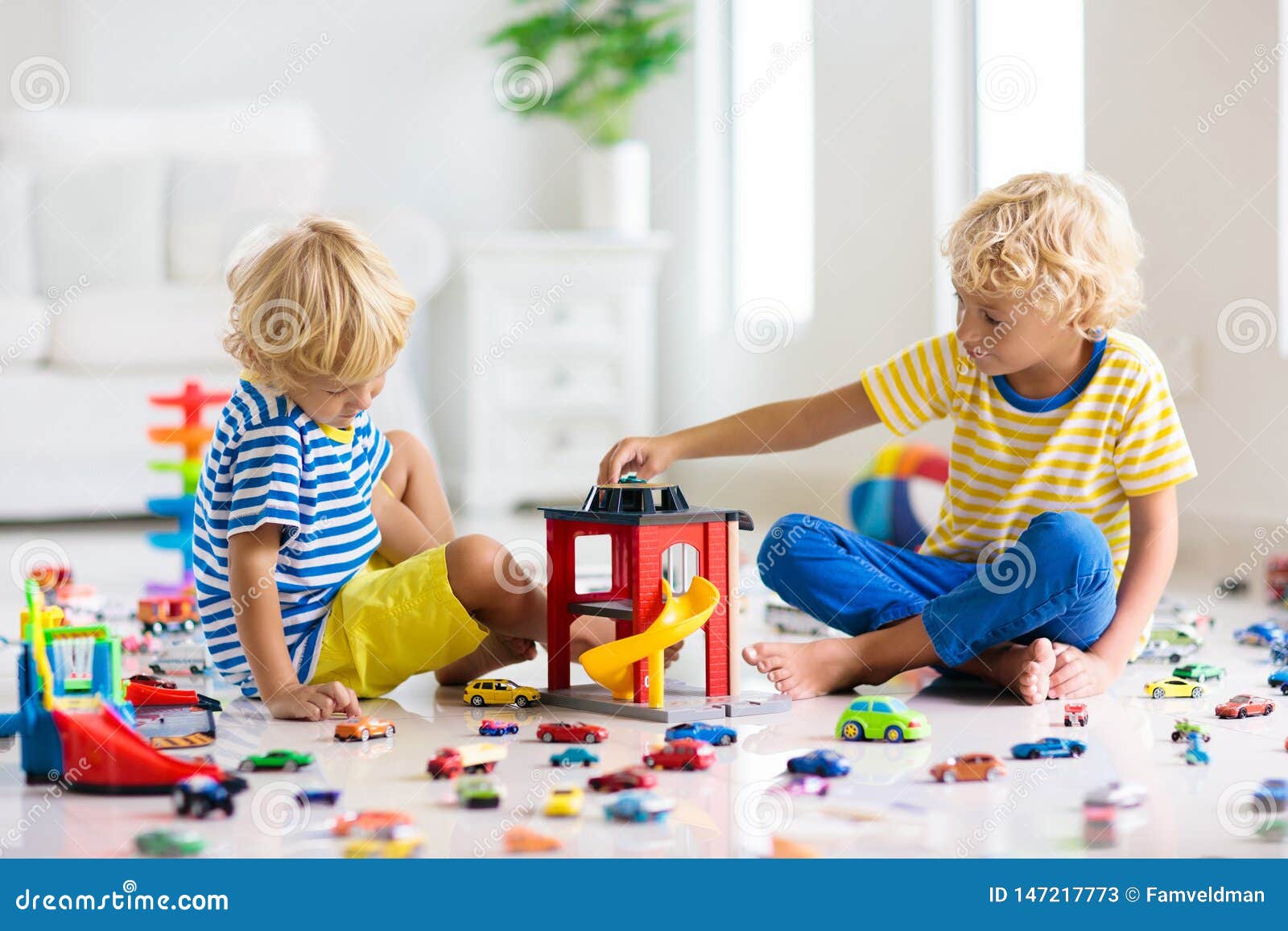 child playing with cars