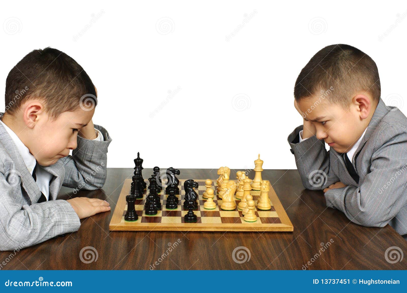 Pupil kid thinking about his next move in a game of chess. Concentrated  little boy sitting at the table and playing chess Stock Photo - Alamy