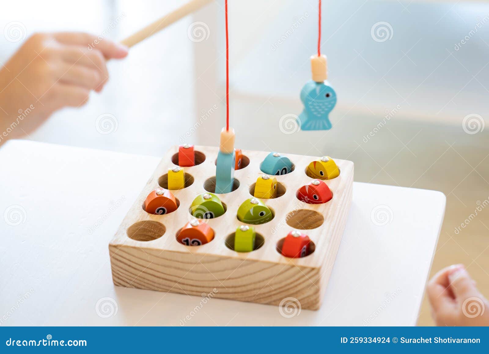 Kids are Playing and Finding the Matched Number in the Wooden Magnetic  Fishing Game, Using Wooden Fishing Pole Provided with Stock Photo - Image  of game, action: 259334924